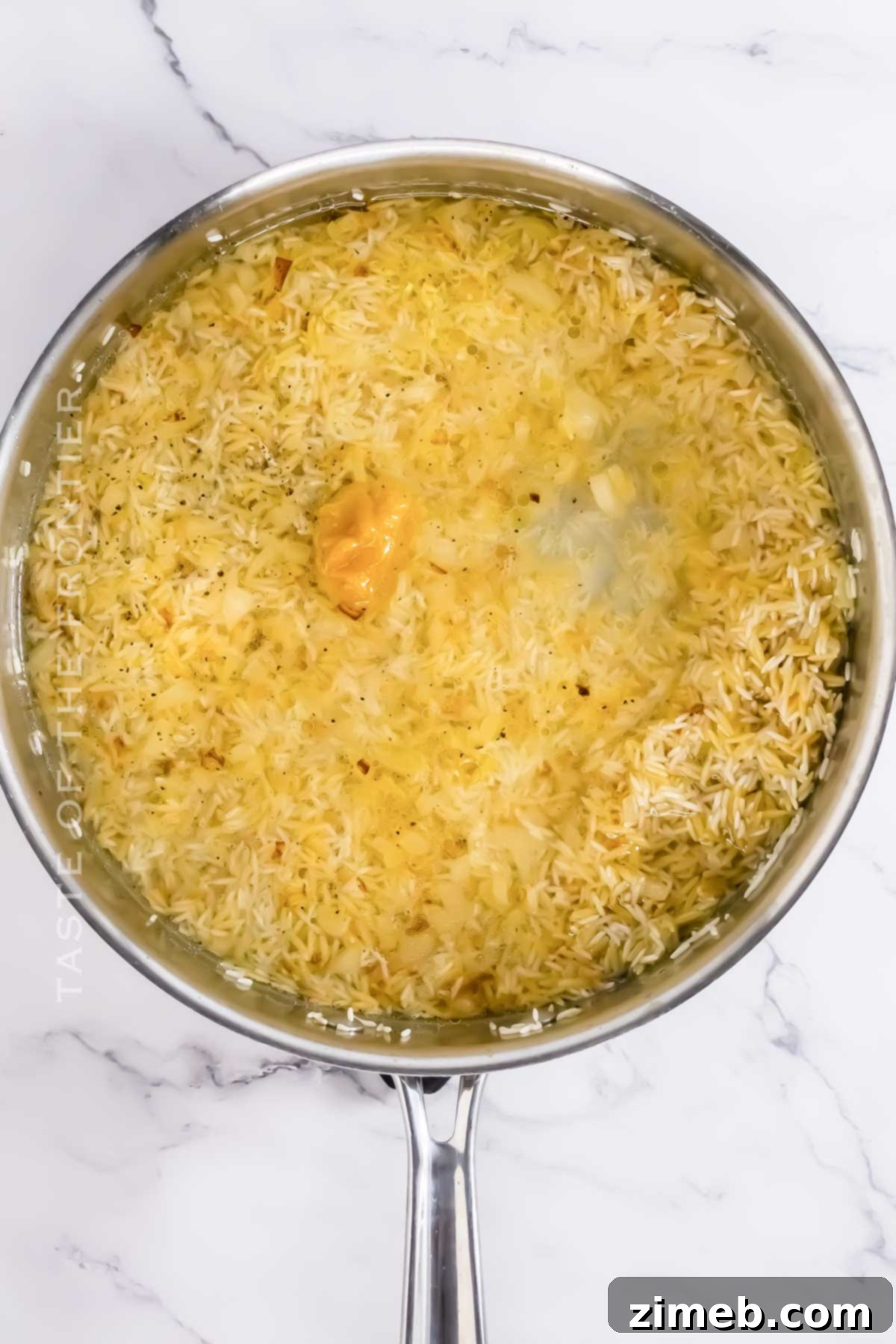 Cooking process of Rice Pilaf with Orzo on stovetop