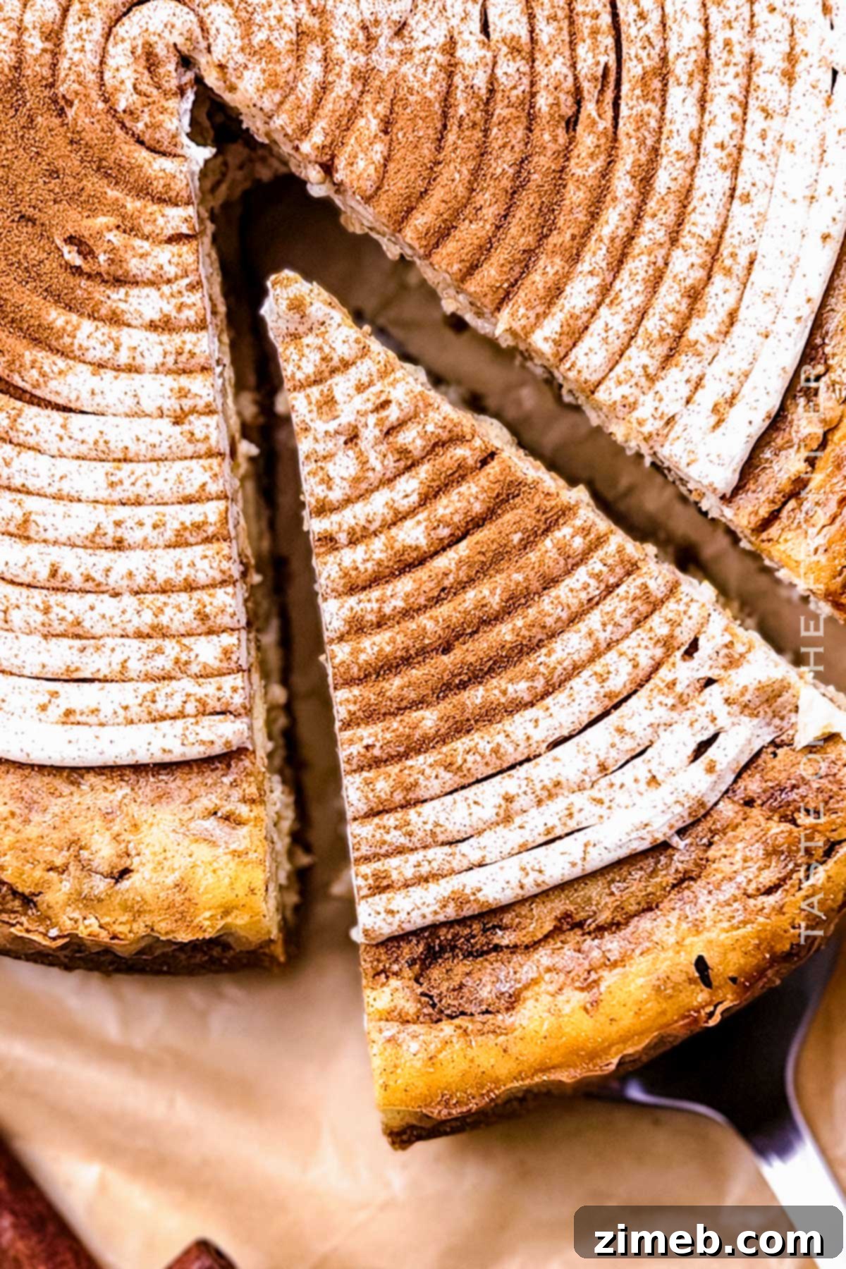 Slice of Cinnamon Roll Cheesecake, showing layers