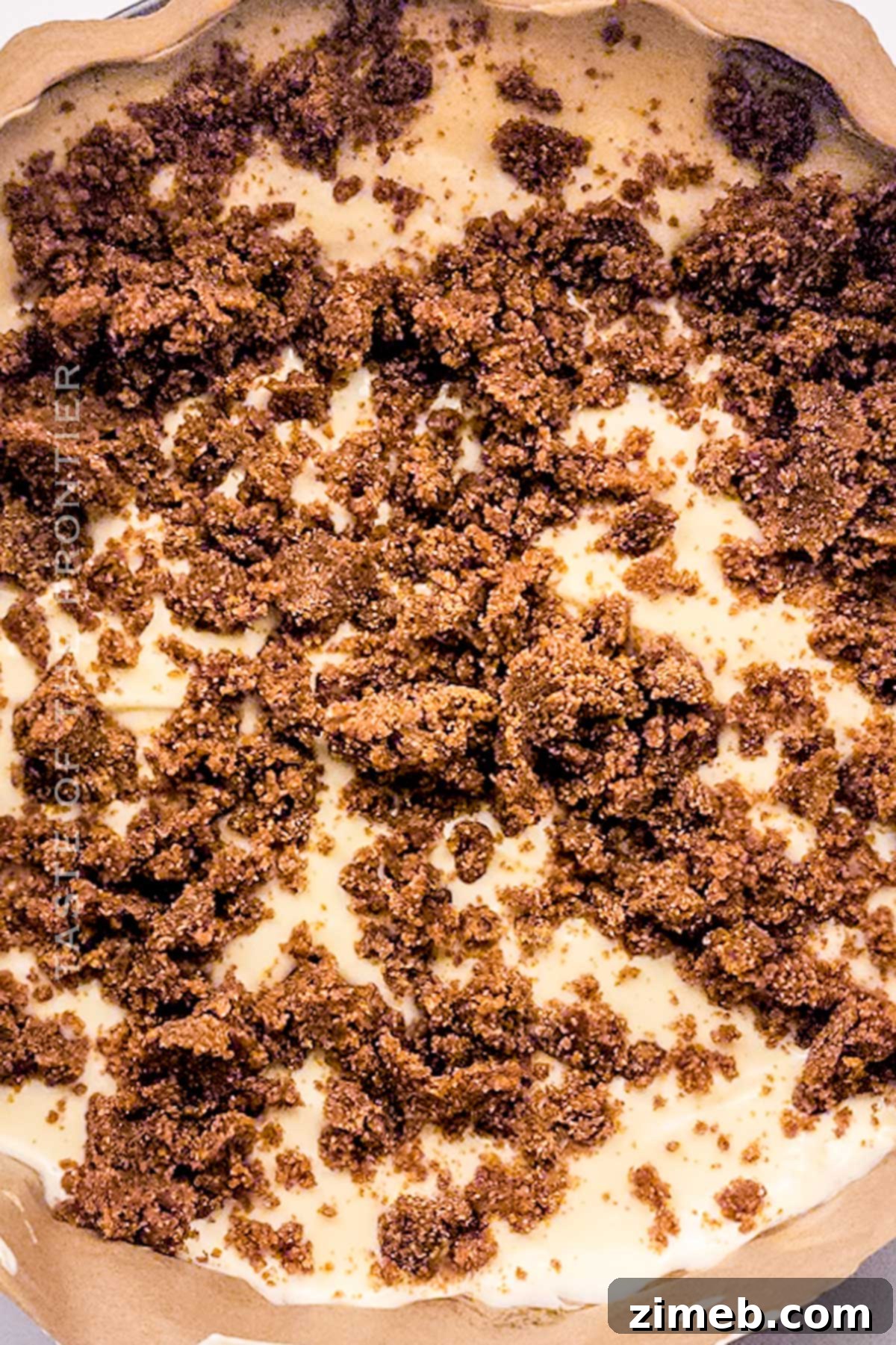 Preparing the Cinnamon Roll Cheesecake for baking