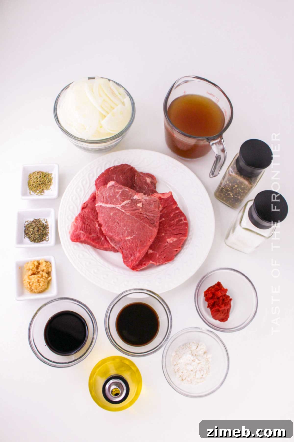 Tender Braised Steak with Caramelized Onions 4 Ingredients laid out for Braised Steak and Onions, including beef, onions, herbs, and sauces.