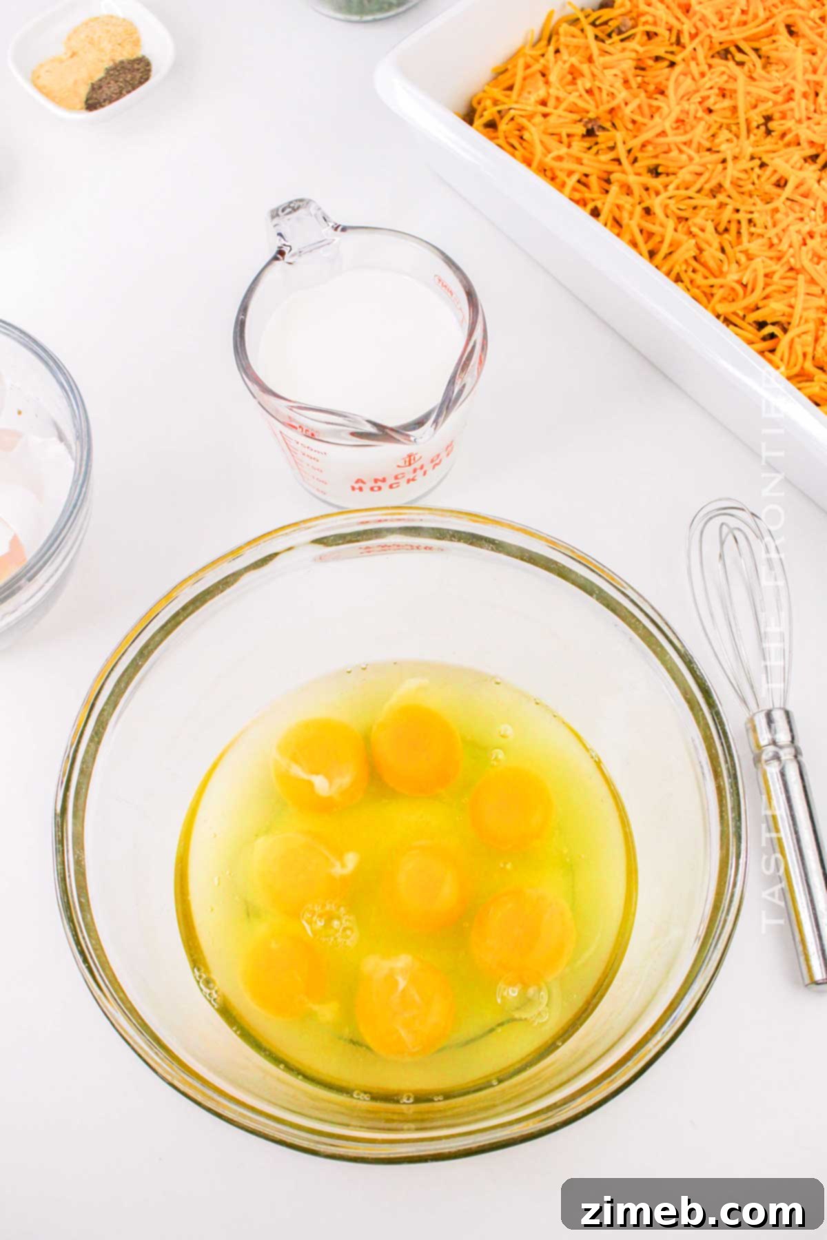 Ultimate Biscuit Breakfast Bake 6 mixing the eggs