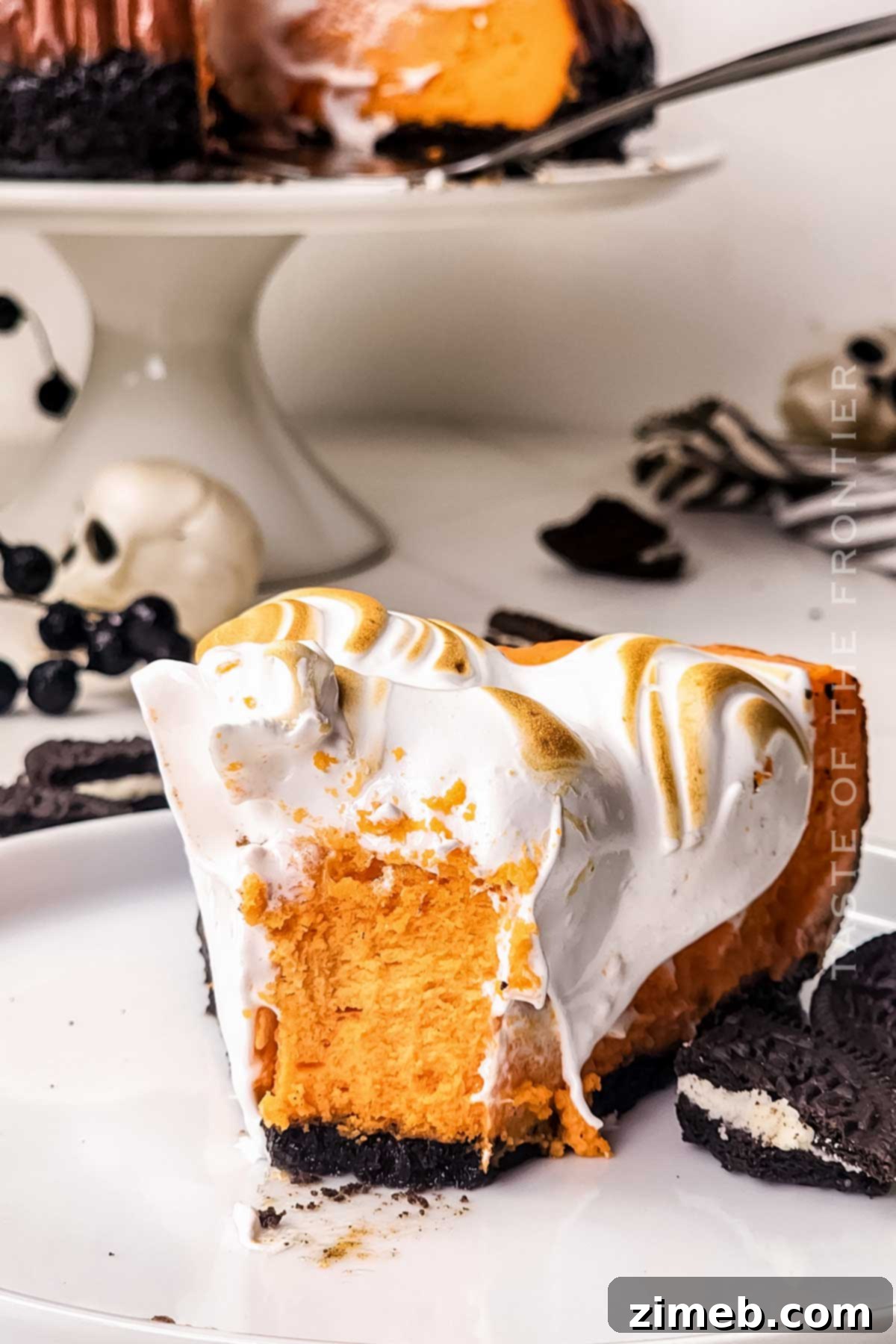 Spooktacular Cheesecake 3 Festive Halloween holiday dessert with creamy orange cheesecake and ghost meringues.