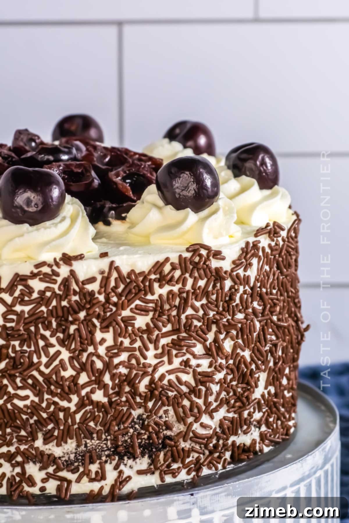 Black Forest Gateau 7 Frosted Black Forest Cake topped with chocolate sprinkles and cherries