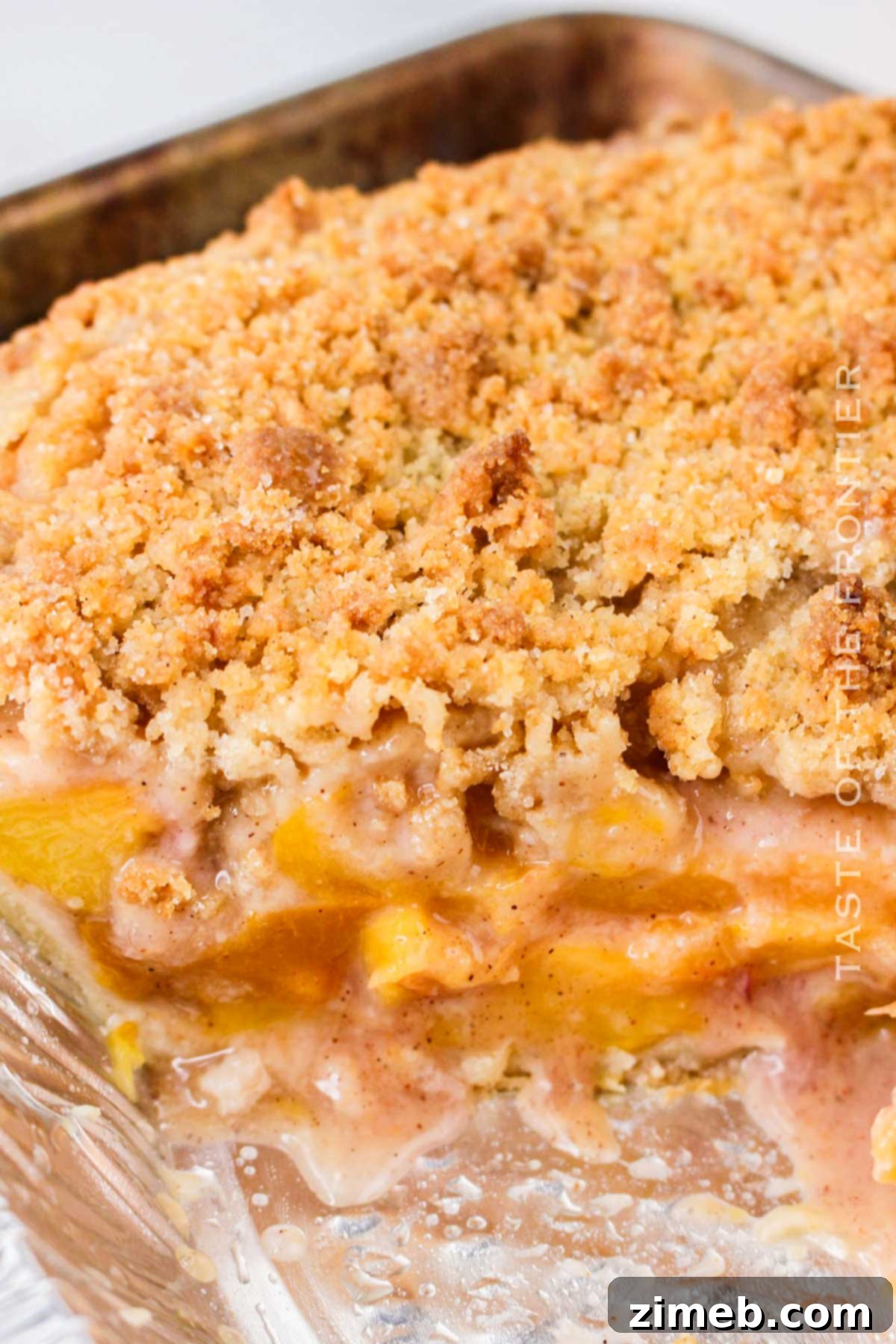 Buttery crumb topping on a peach pie