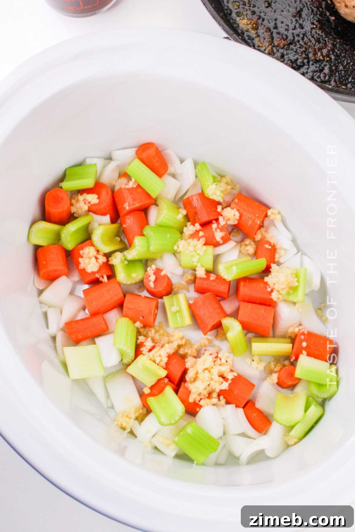 Slow Cooker Sirloin Tip Pot Roast 6 adding the veggies to the cooker with the roast