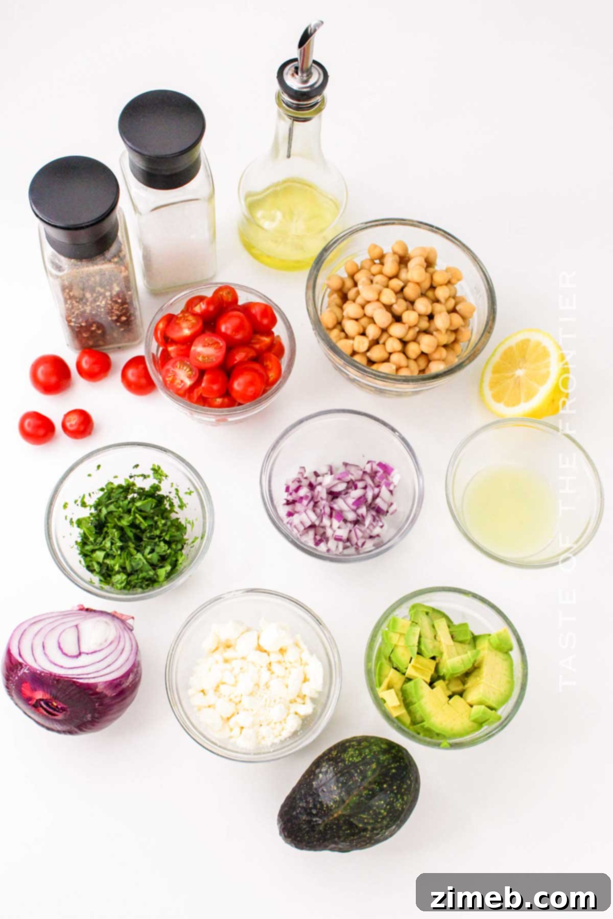 Ingredients for Chickpea Avocado Salad arranged on a cutting board.