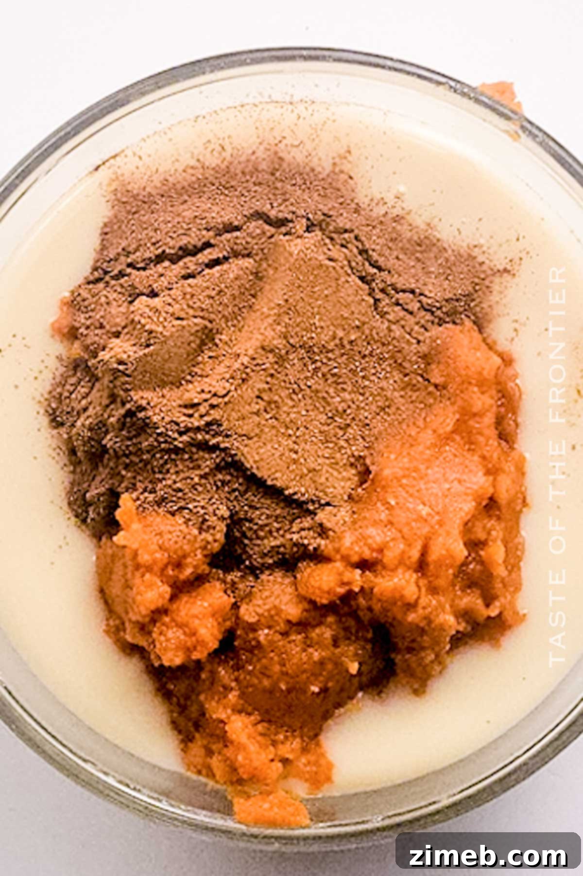 Mixing pumpkin puree and spices into sweetened condensed milk