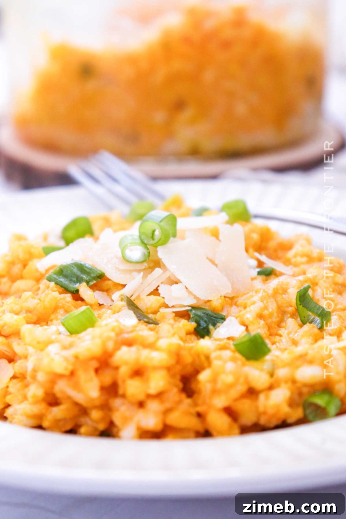Velvet Pumpkin Risotto 14 A beautifully styled creamy fall side dish, Pumpkin Risotto, in a white bowl, ready to be served.