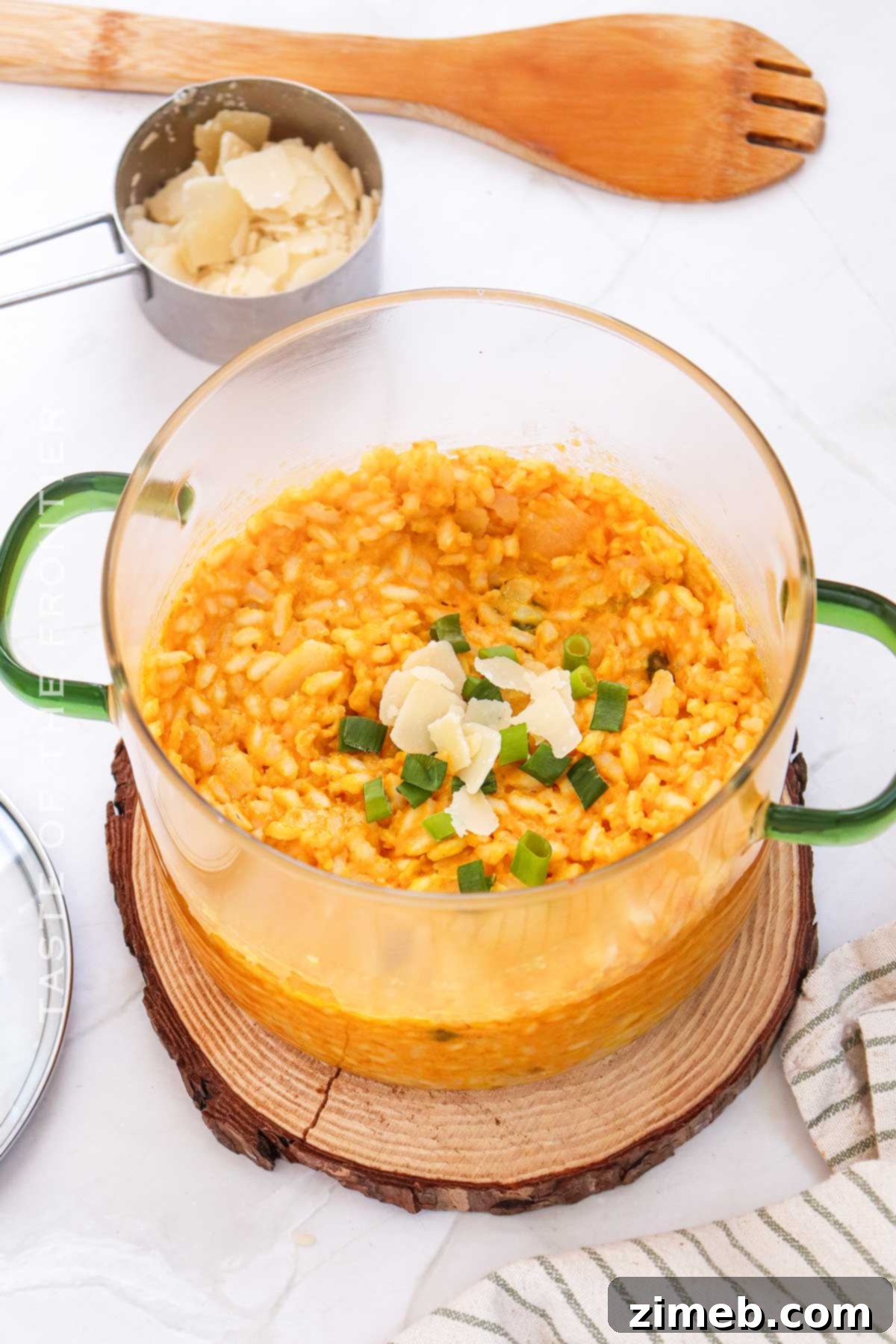 Velvet Pumpkin Risotto 3 A beautifully presented pumpkin side dish, featuring creamy risotto with hints of orange and green garnish, perfect for any fall gathering.