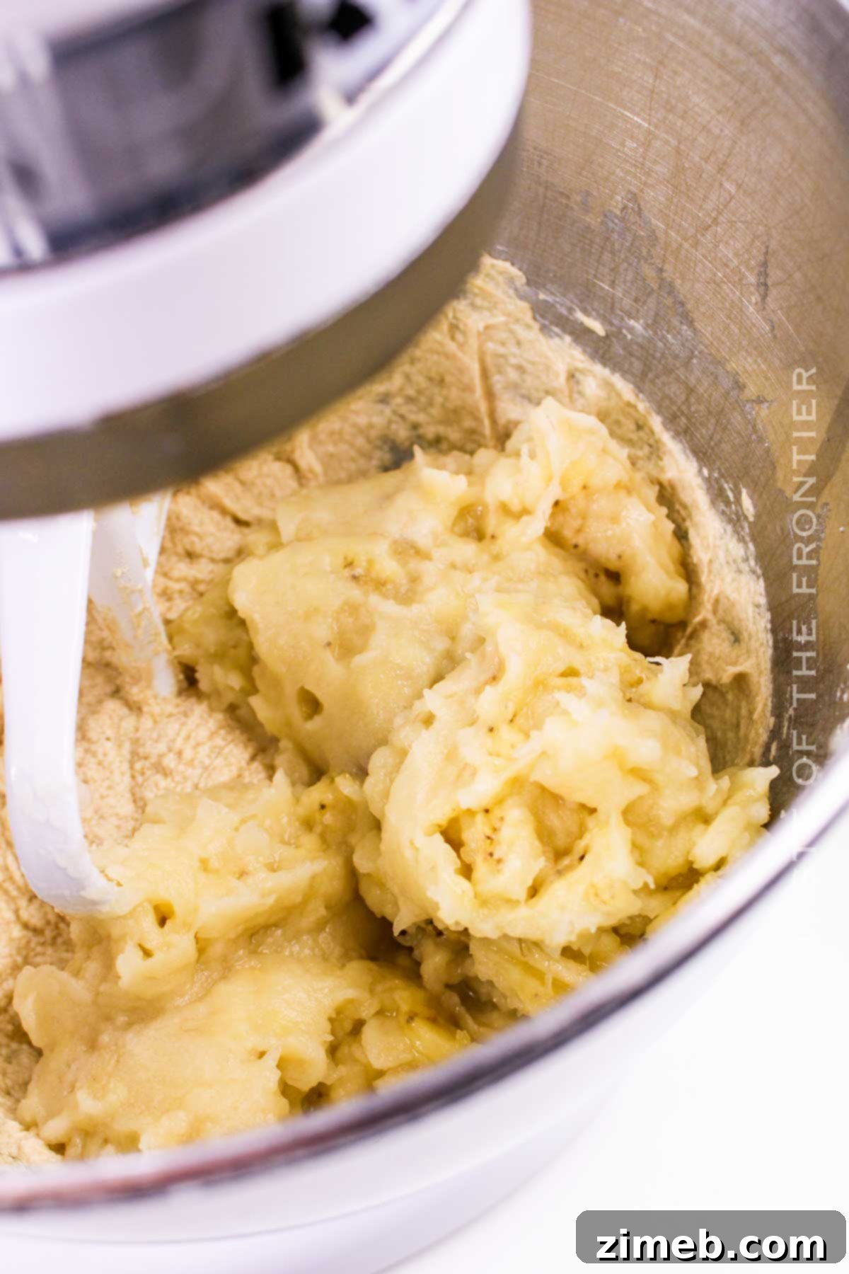 Mixing mashed bananas into the batter
