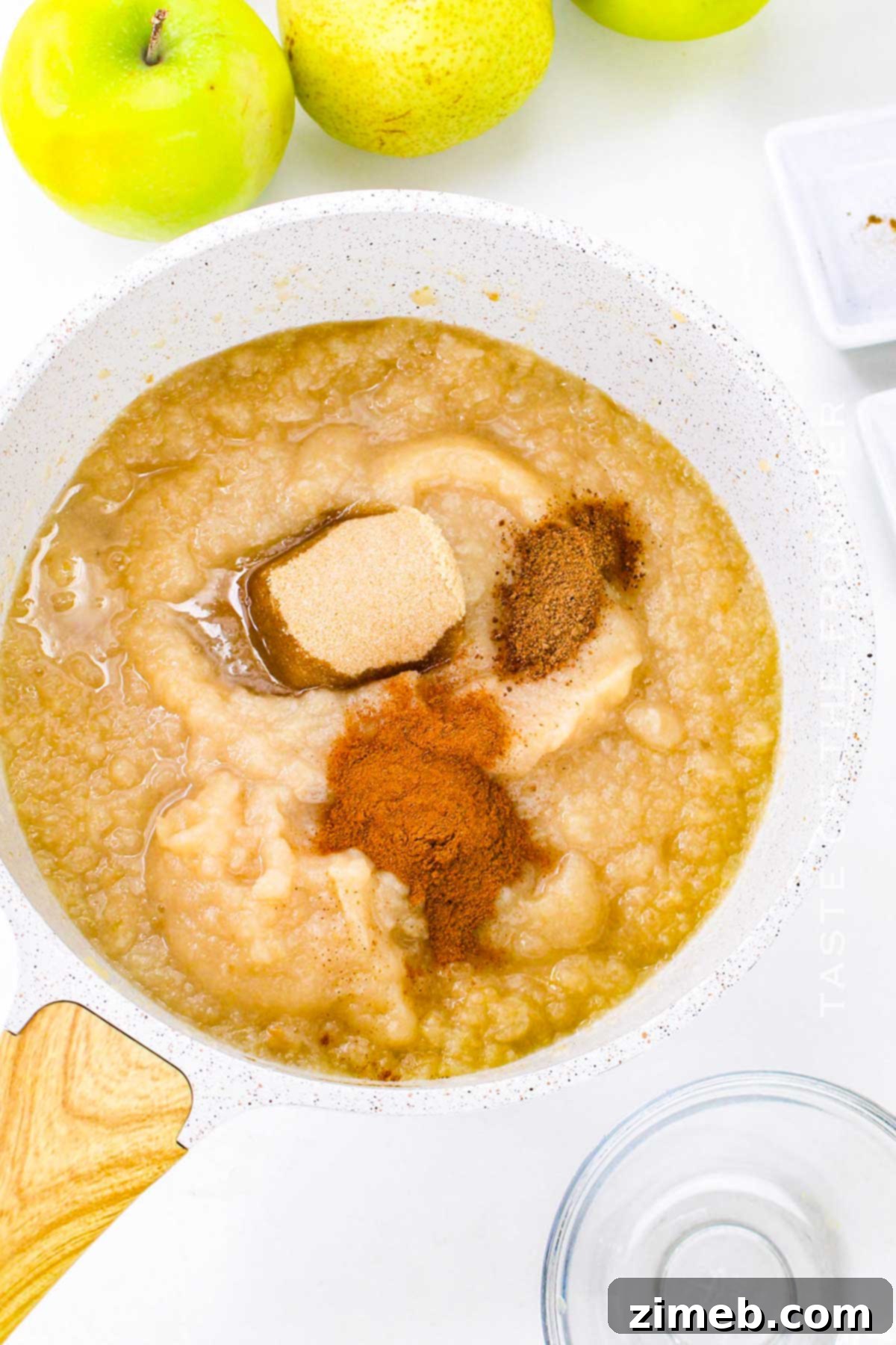 Adding warm spices like cinnamon and nutmeg to cooking fruit for Apple Pear Sauce.