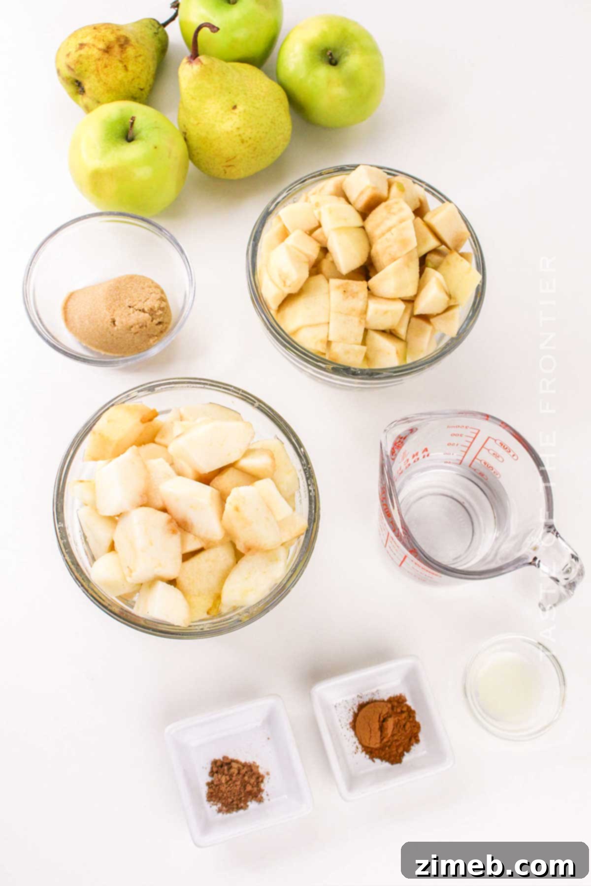 Fresh apples, pears, and spices laid out as ingredients for homemade Apple Pear Sauce.