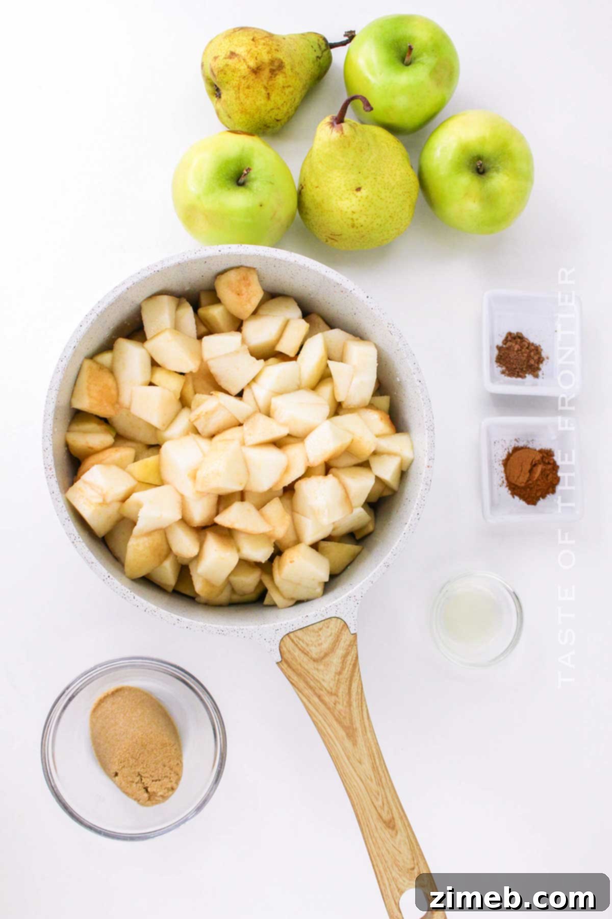Apples and pears simmering in a pot, cooking down to create a flavorful sauce.