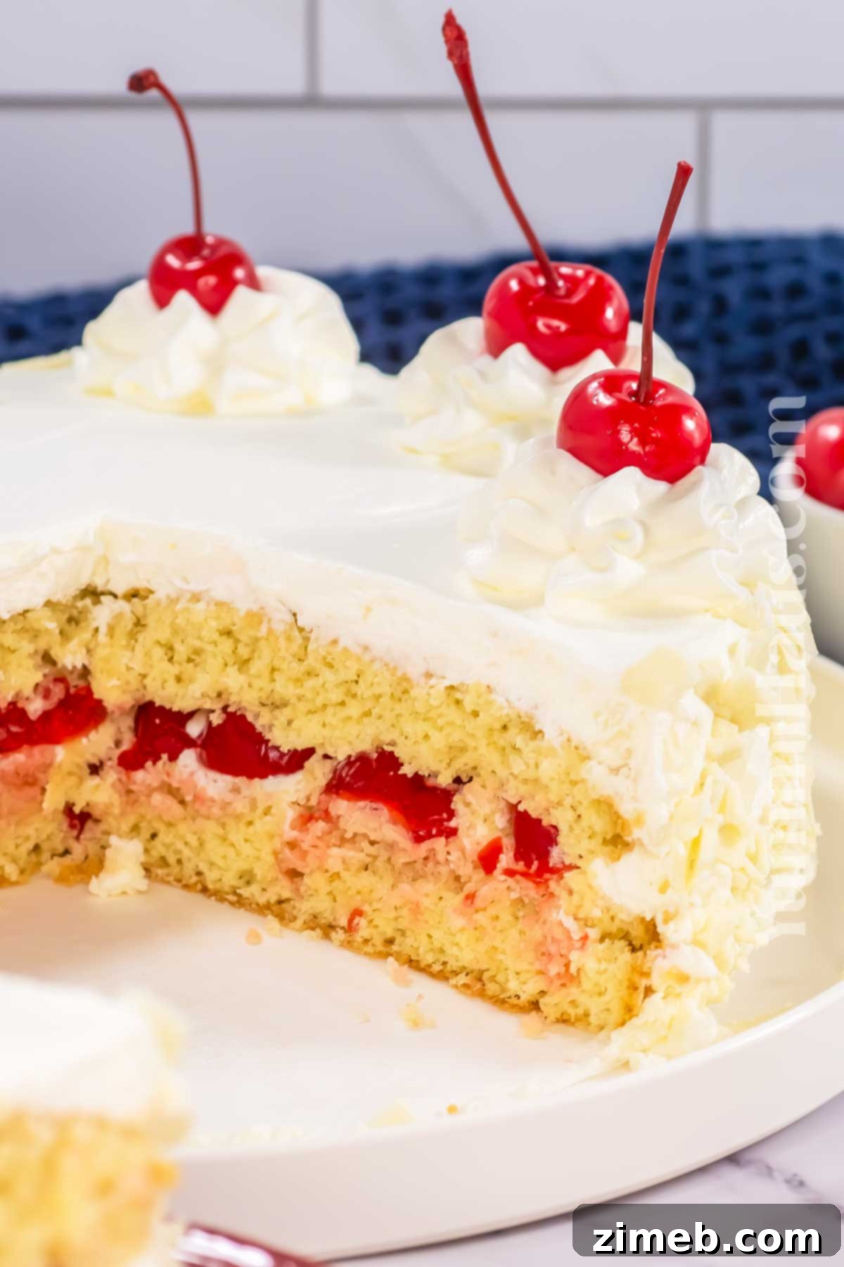 Enchanted White Forest Cake 3 Vanilla cherry cake recipe with whipped cream and white chocolate garnish