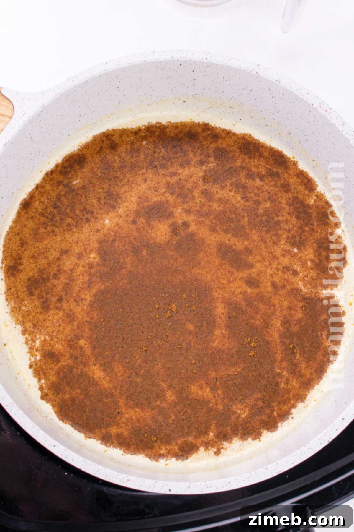 Autumn Pumpkin Chai Latte 5 Milk and pumpkin puree simmering gently in a saucepan, creating the creamy base for Pumpkin Spice Chai Latte.