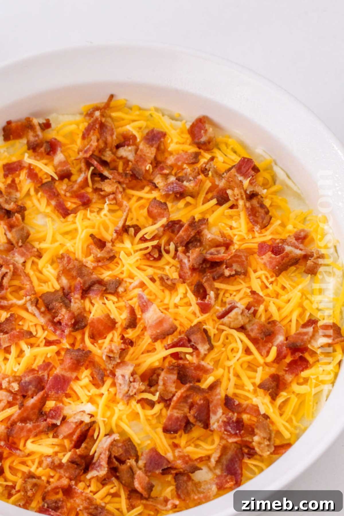 adding the cheese and bacon