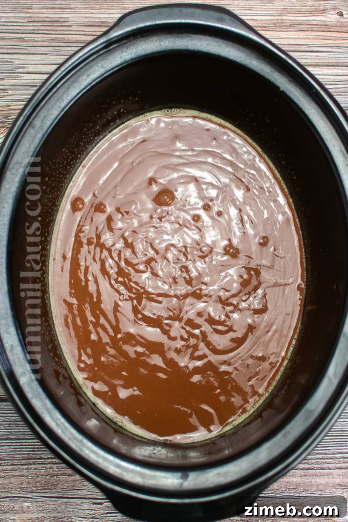 Cake batter with pudding mix in the crockpot, ready to cook