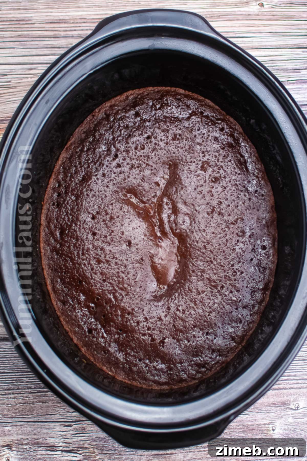 Making cake in the crockpot, showing the pudding layer
