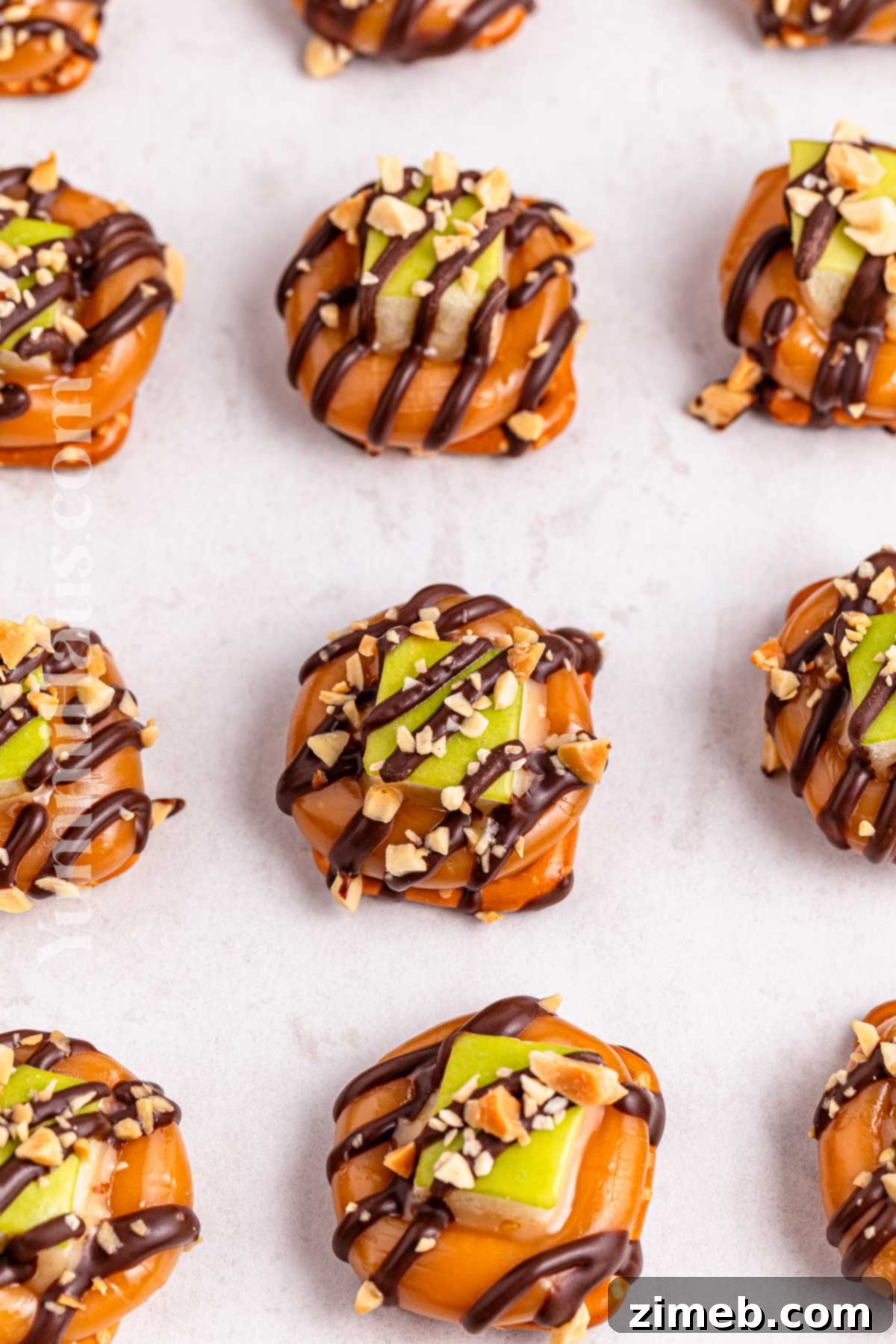 Sweet and Salty Caramel Apple Pretzel Bites 7 Decorating caramel apple pretzel bites with chopped nuts for added texture and flavor.