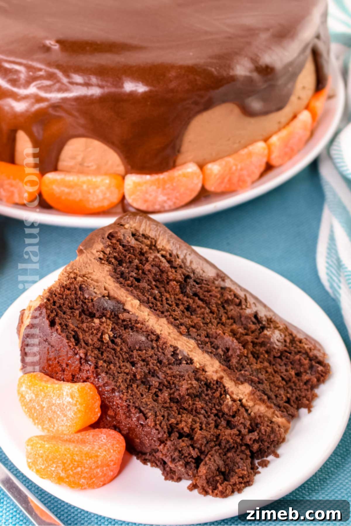 A beautifully decorated slice of chocolate orange cake ready to be served.