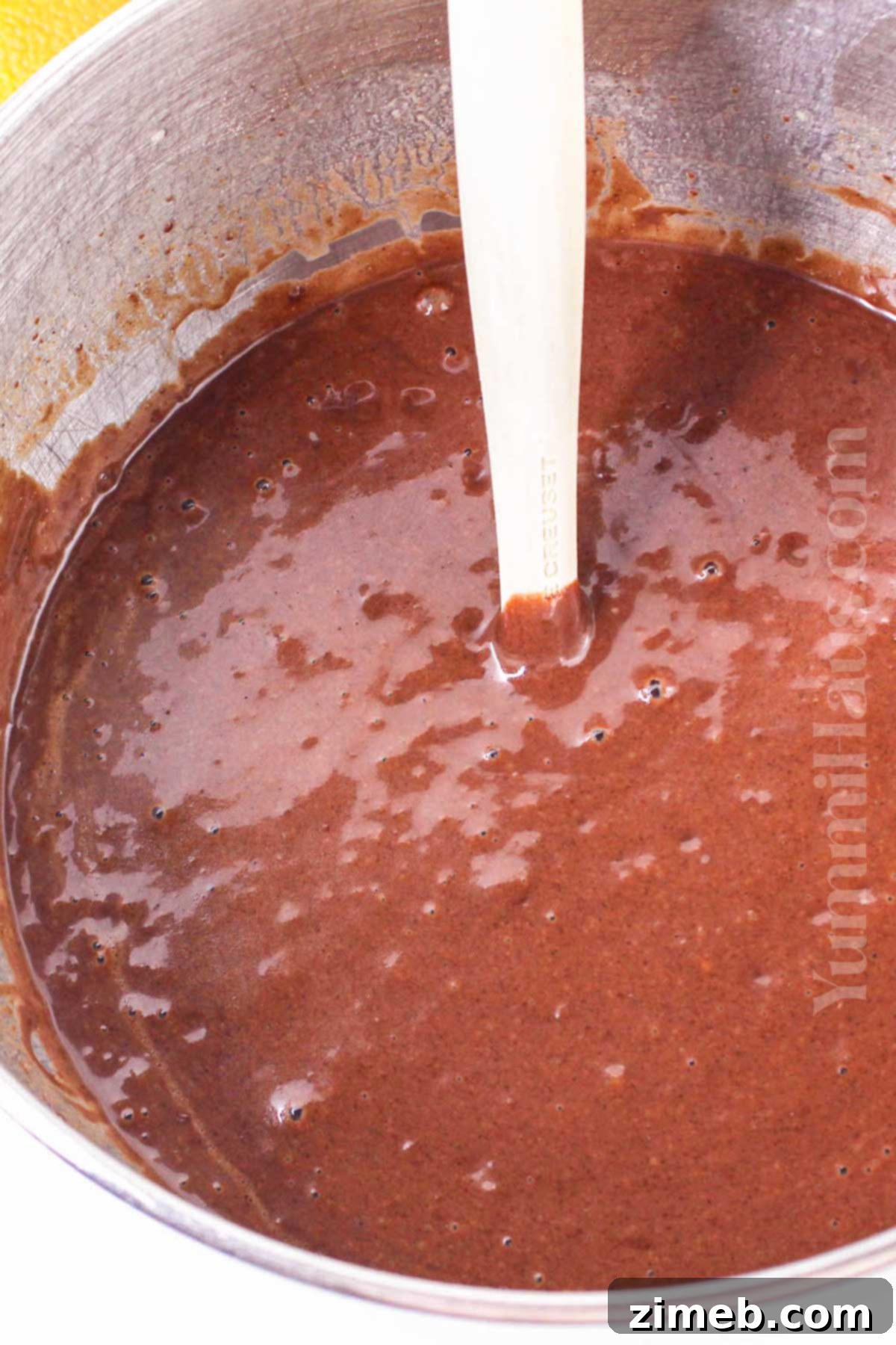 Mixing homemade chocolate orange cake batter in a large bowl.
