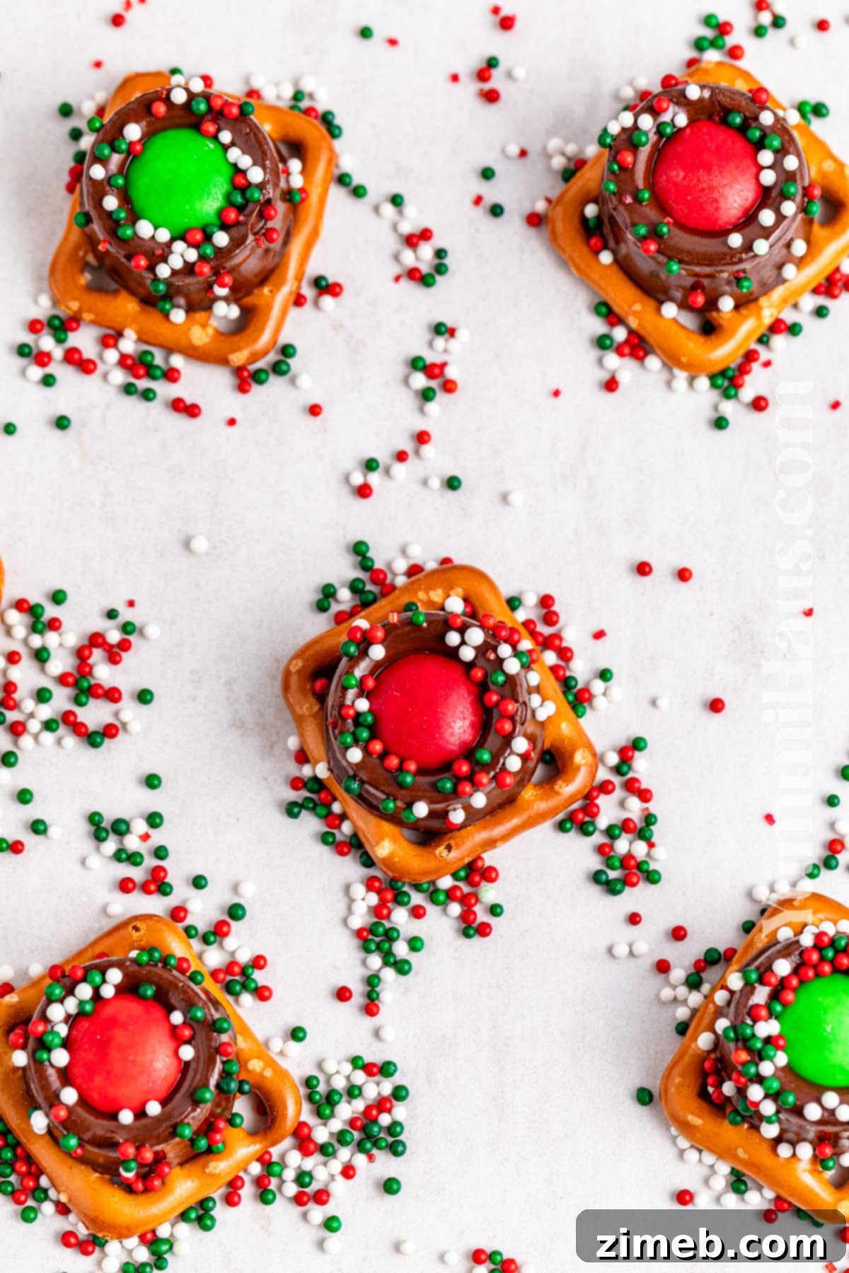 Adding festive sprinkles to Rolo Pretzel Treats