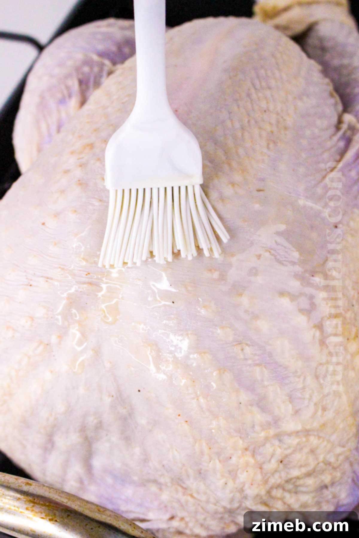 Preparing a brined turkey for roasting, coated in seasoning