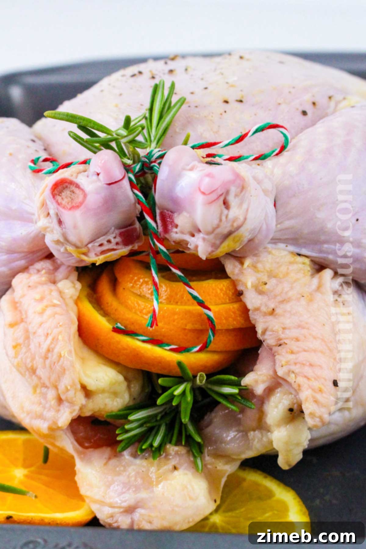 The Yuletide Bird 6 How to make Christmas Chicken, showing a close-up of the roasted chicken on a cutting board.