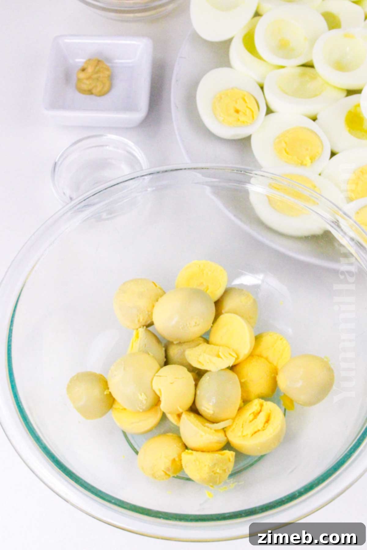 Merry & Bright Deviled Eggs 6 Mashing egg yolks for deviled eggs