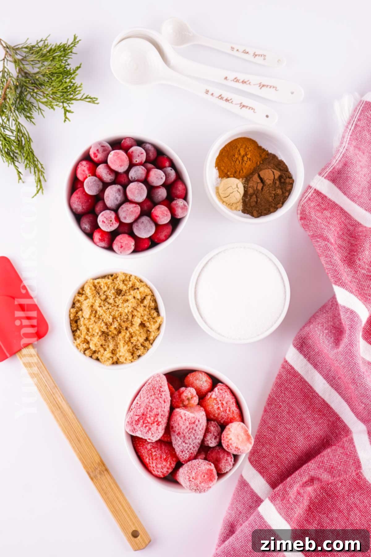 Yuletide Groove 4 Christmas Jam ingredients, showcasing frozen cranberries, strawberries, and spices.