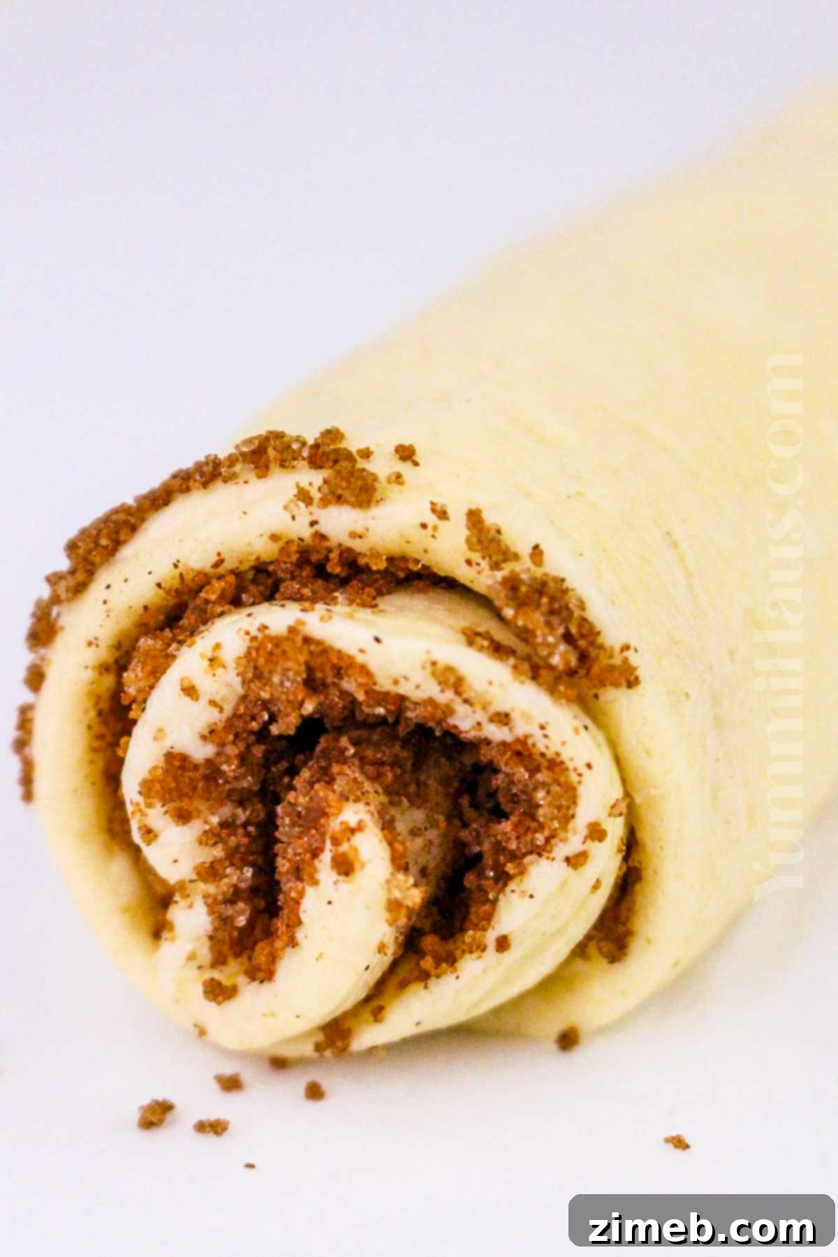 Easy Air Fryer Cinnamon Rolls 6 rolling the dough with sugar and cinnamon