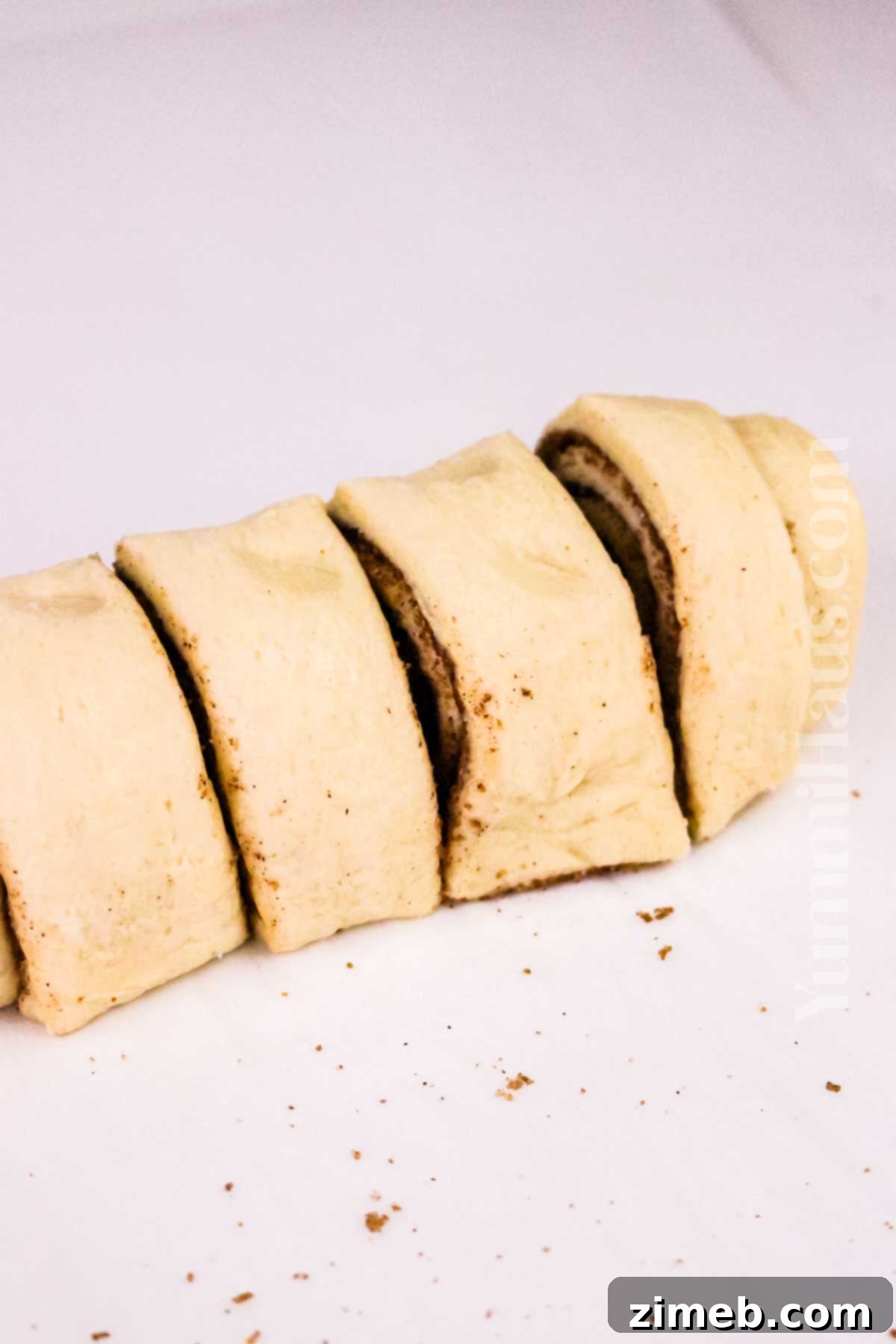 Easy Air Fryer Cinnamon Rolls 7 slicing the dough to fry