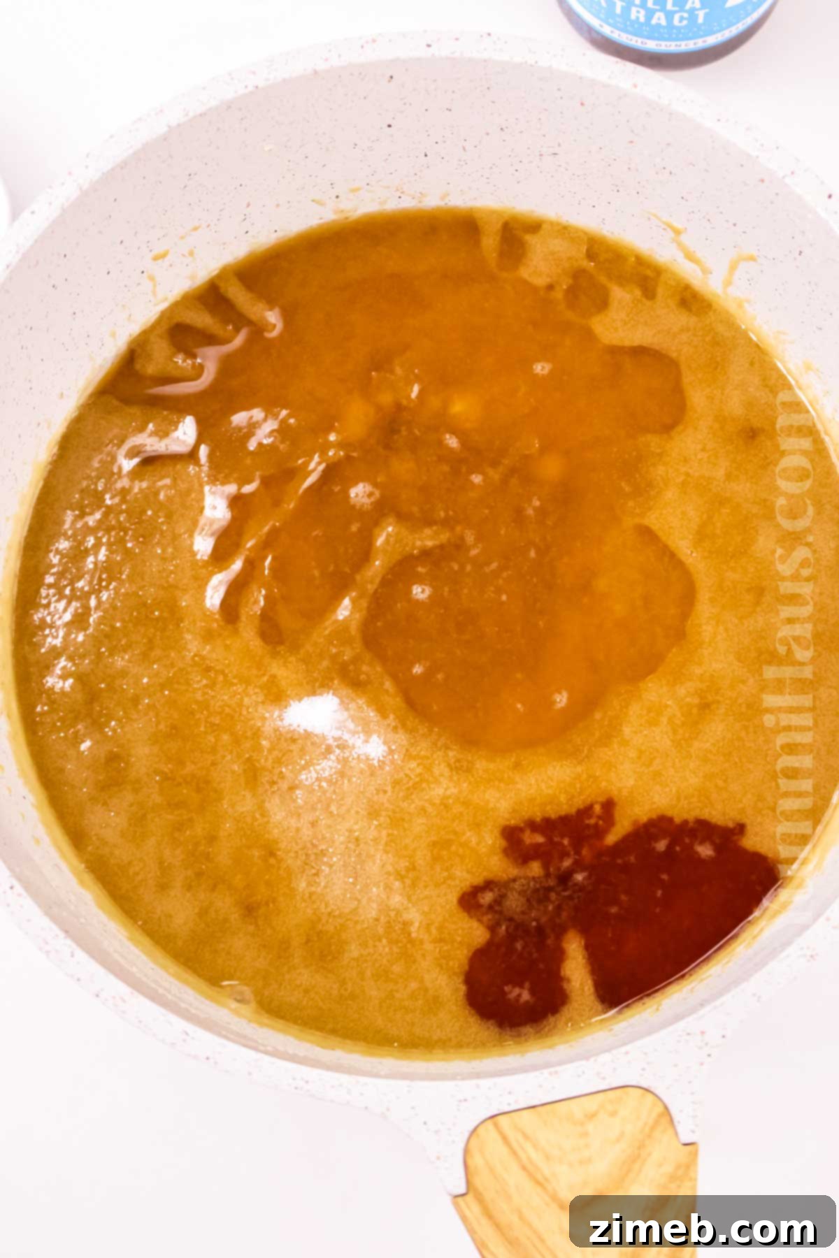 Decadent Rum Sauce 7 Cooking the rum sauce, stirring gently in a saucepan.