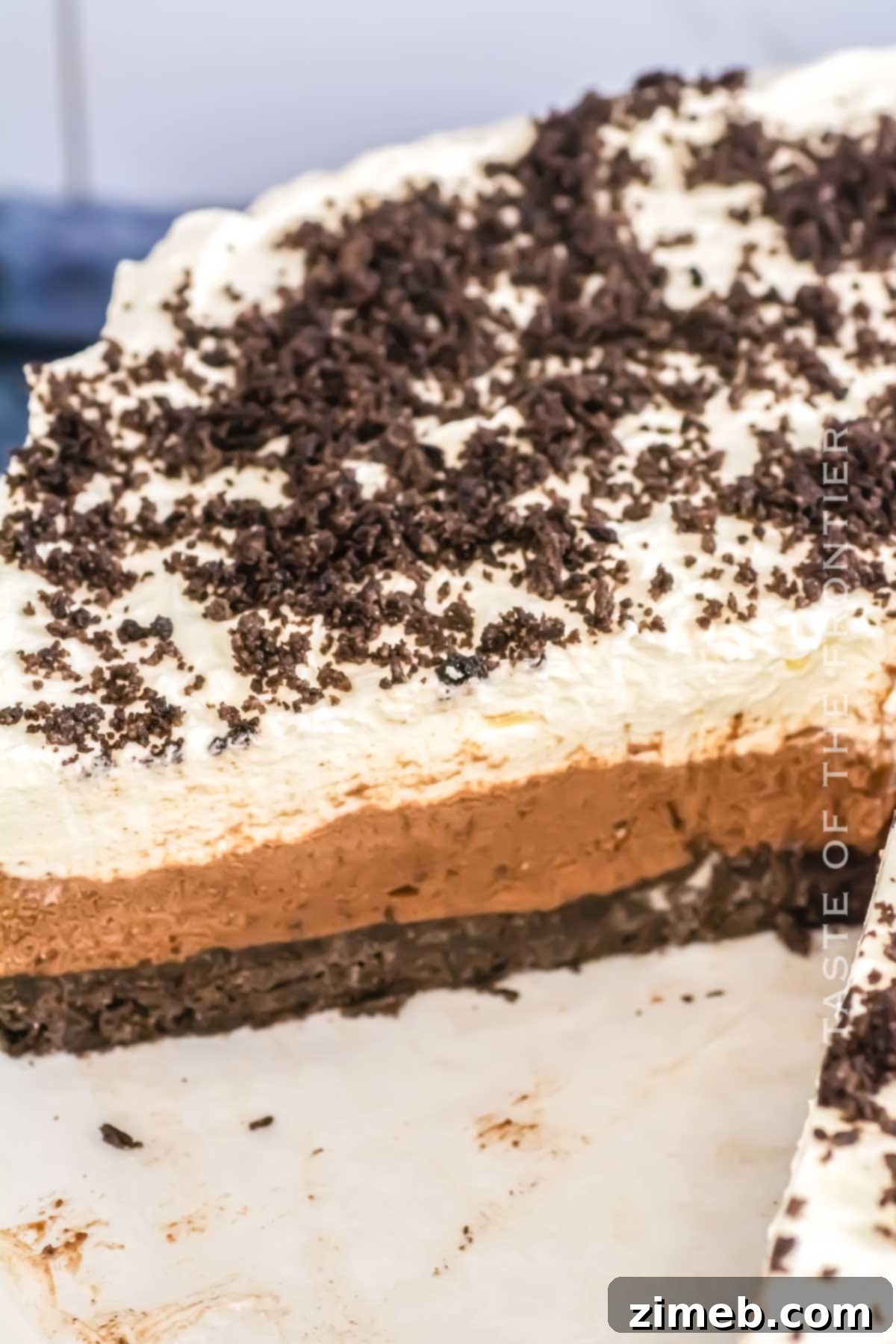 Decadent Oreo Mousse Cake 7 Delicious no-bake Oreo dessert slice on a plate, showing multiple layers.