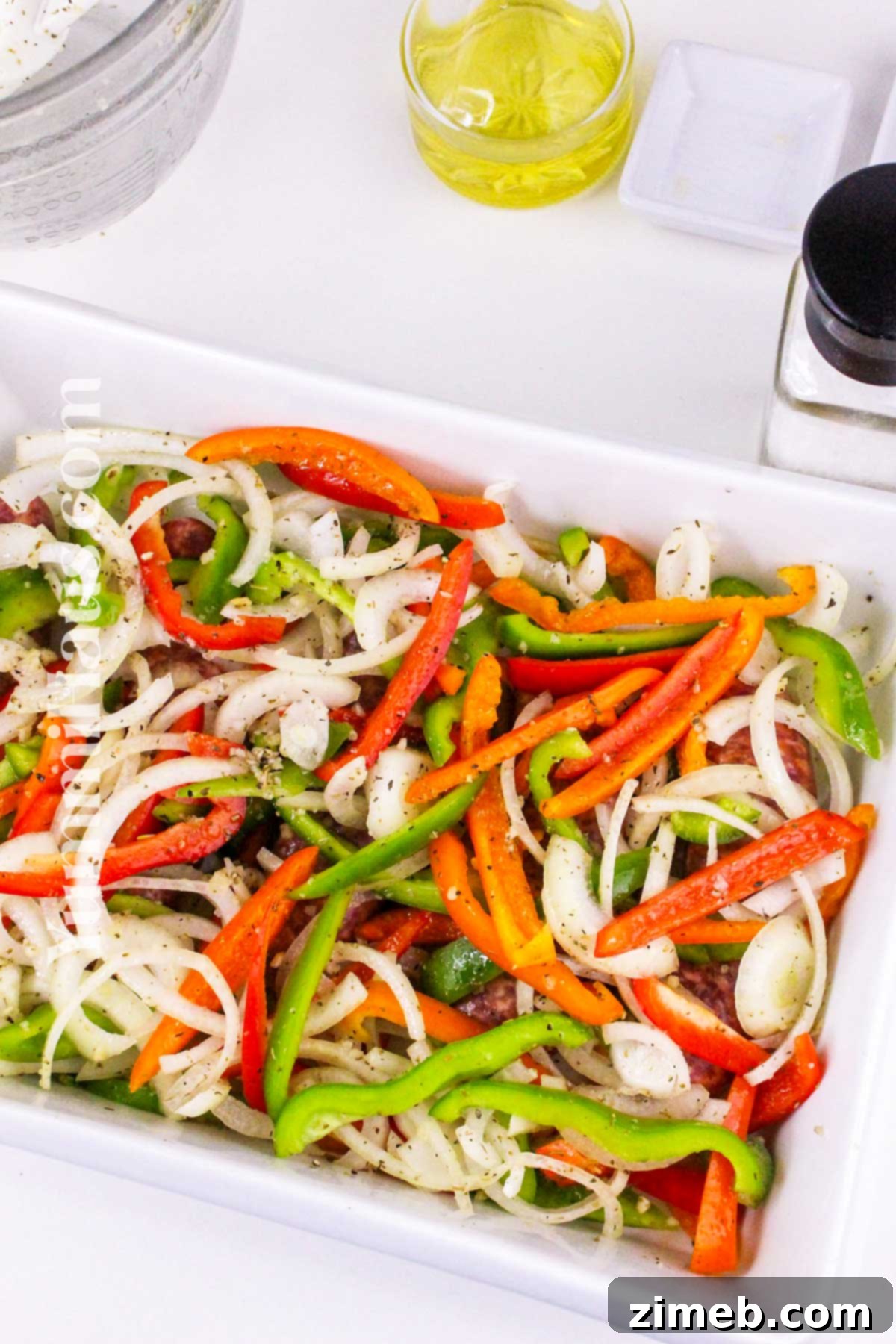 Step-by-step instructions on how to make Baked Italian Sausage with vibrant peppers.