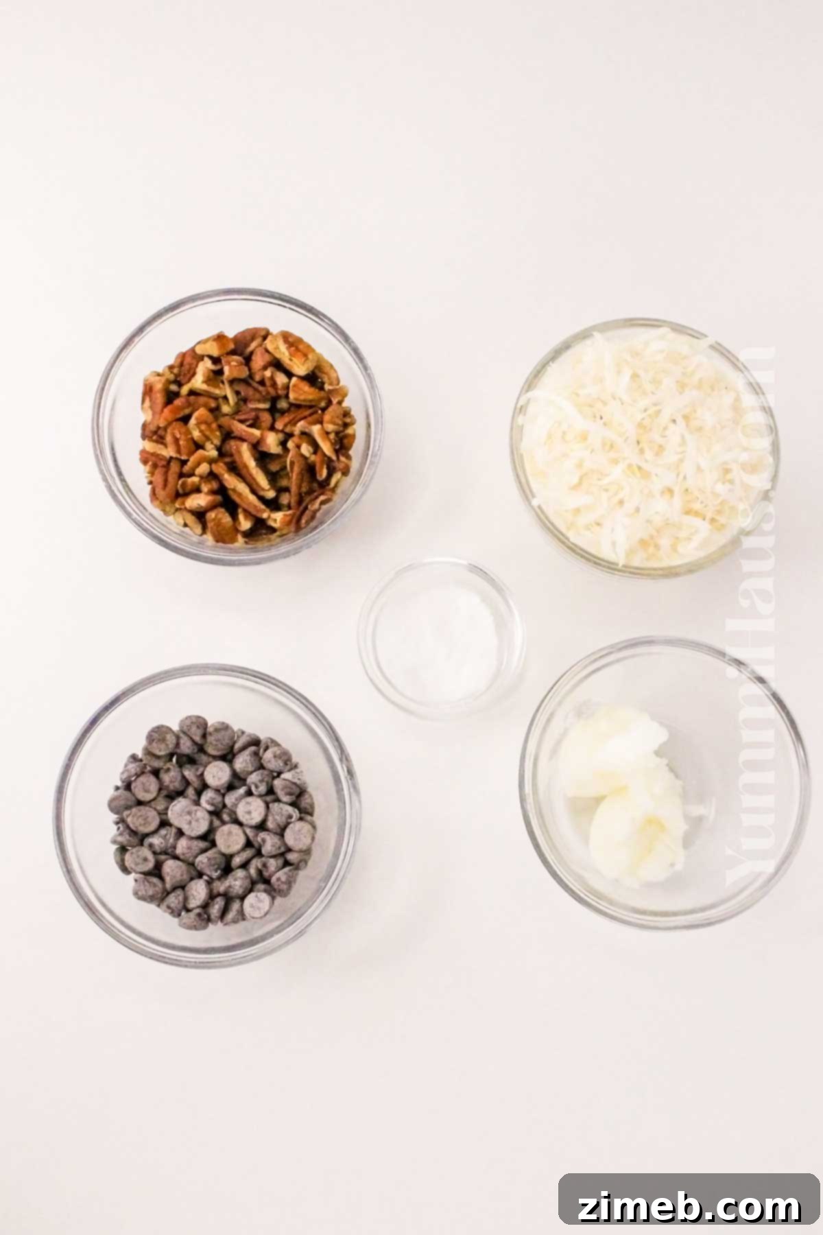 Ingredients for Keto Coconut Clusters including unsweetened coconut, chocolate chips, and nuts