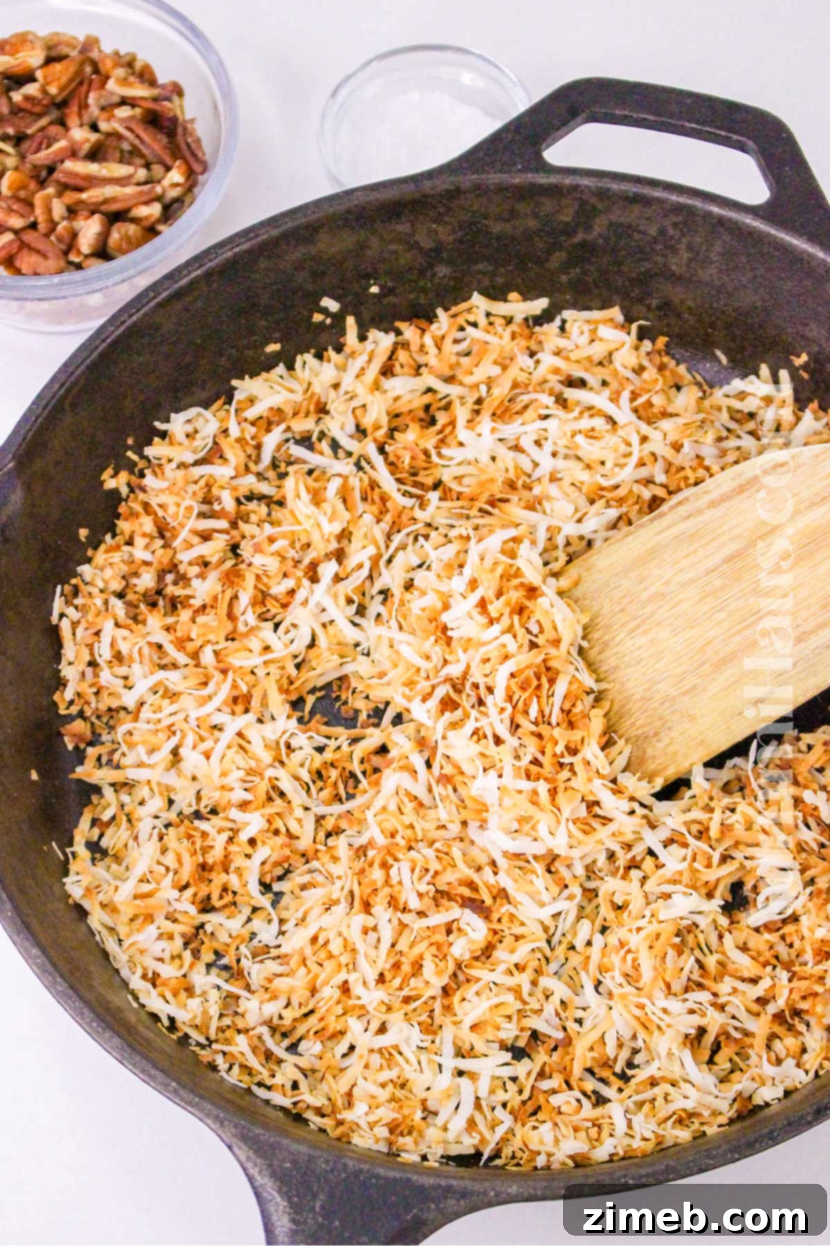 Toasting shredded coconut in a skillet for keto clusters
