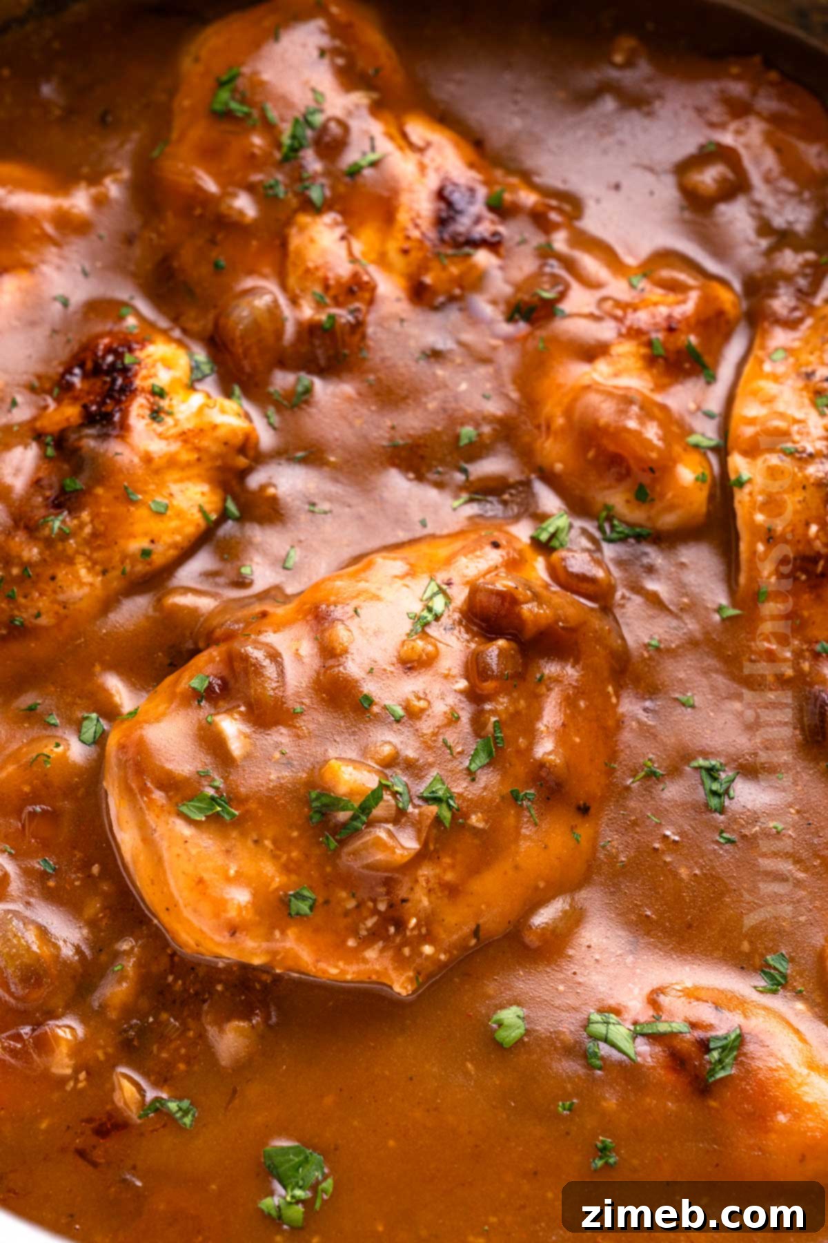 Homestyle Chicken with Silky Gravy 8 Simmering Chicken in Gravy in a Skillet