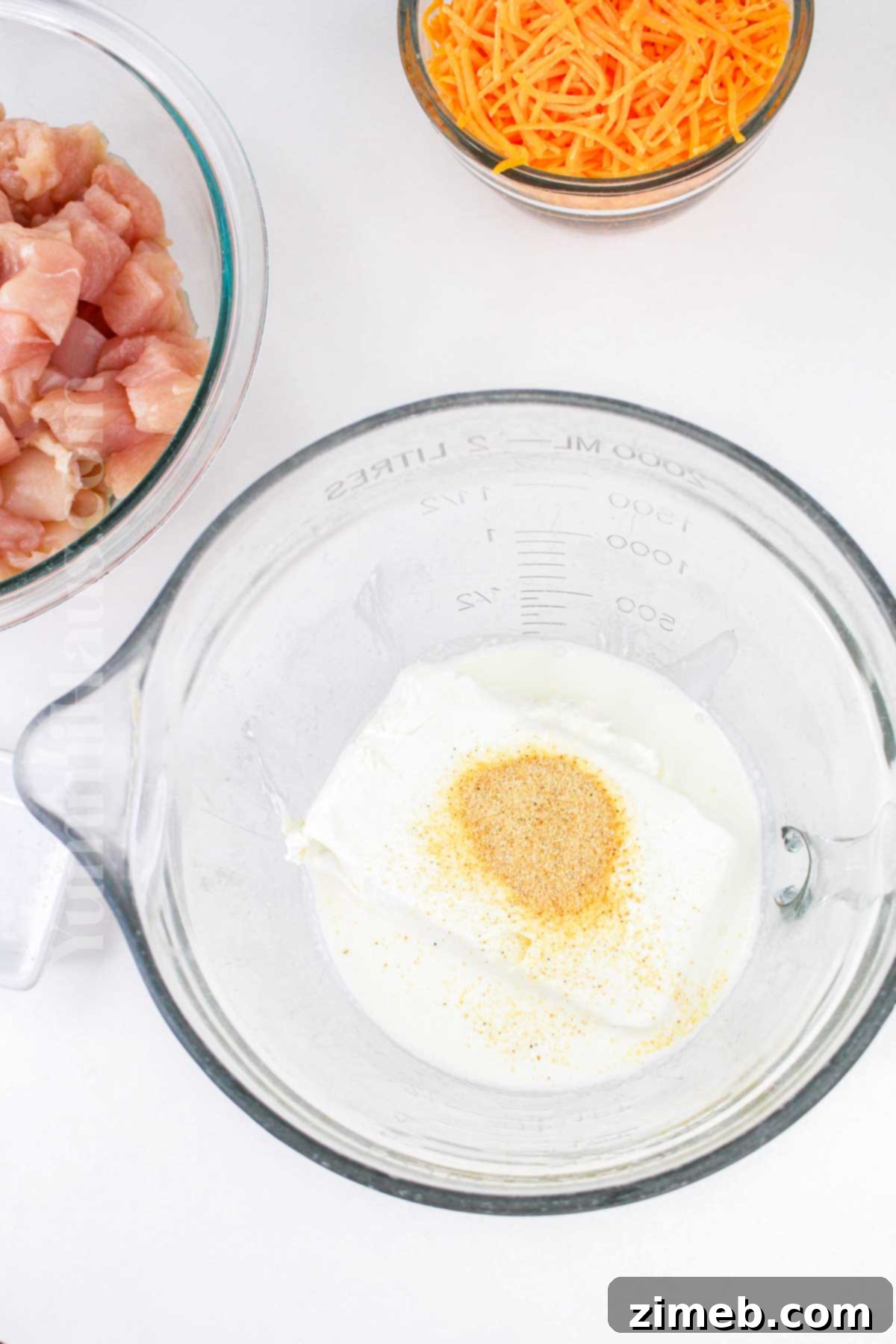 Mixing cheese and seasonings for creamy casserole