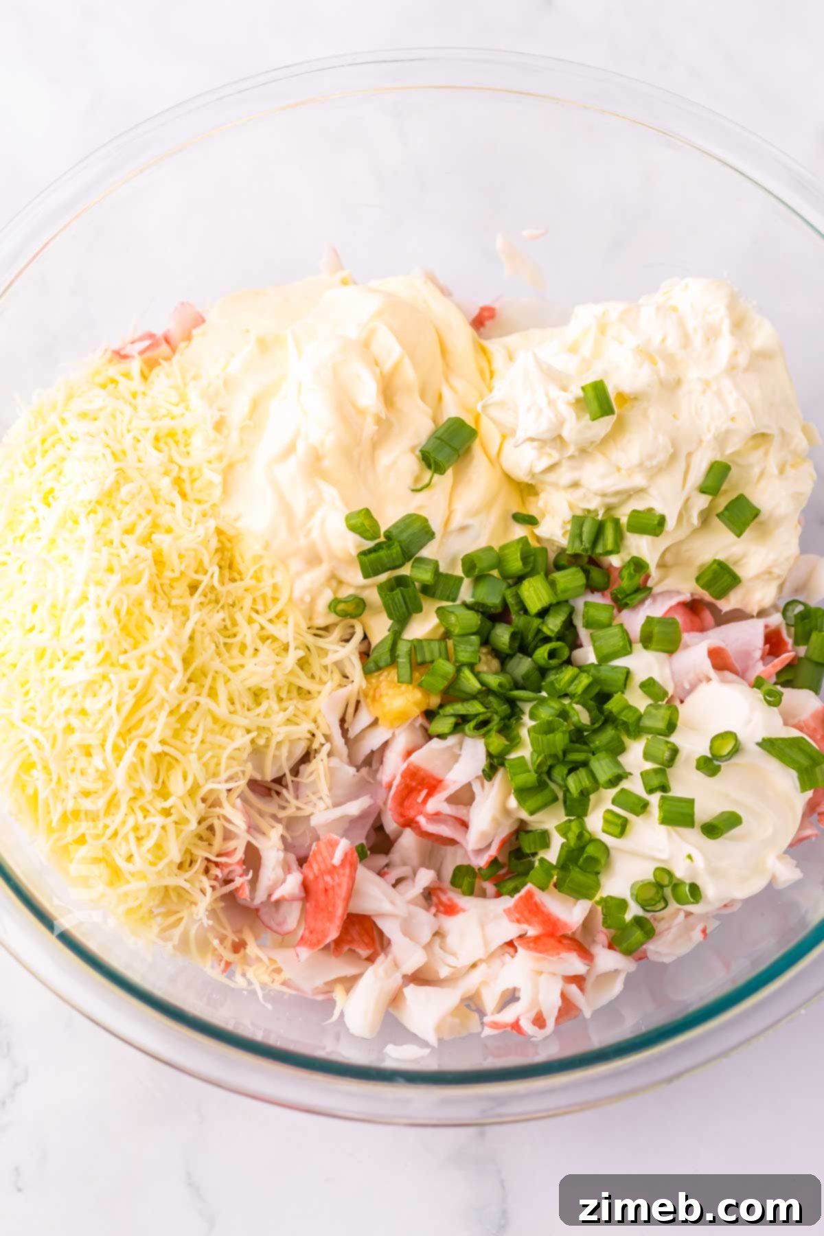 Creamy Wonton Crab Dip 5 Crab Rangoon Dip in a baking dish, ready to be served with dippers.
