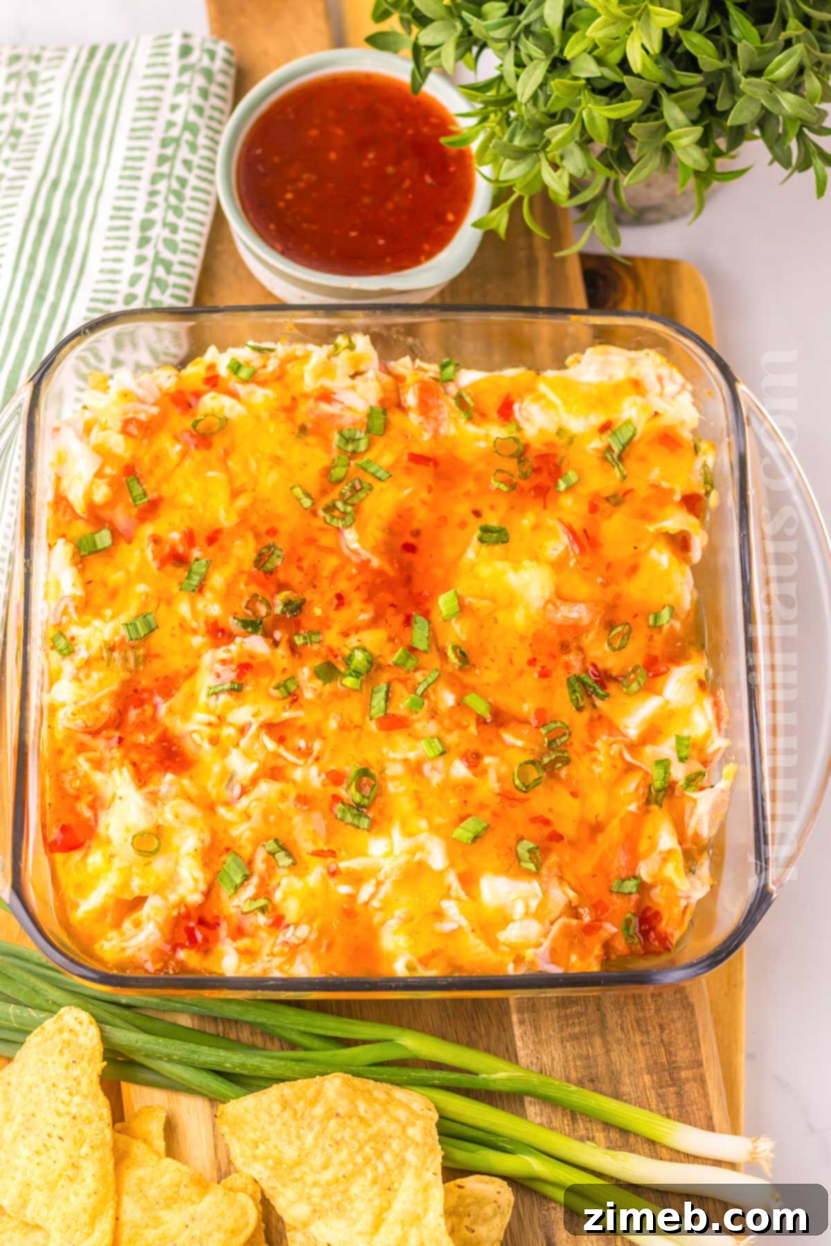 Creamy Wonton Crab Dip 7 Crab Rangoon Dip recipe served with wonton chips and sweet chili sauce.