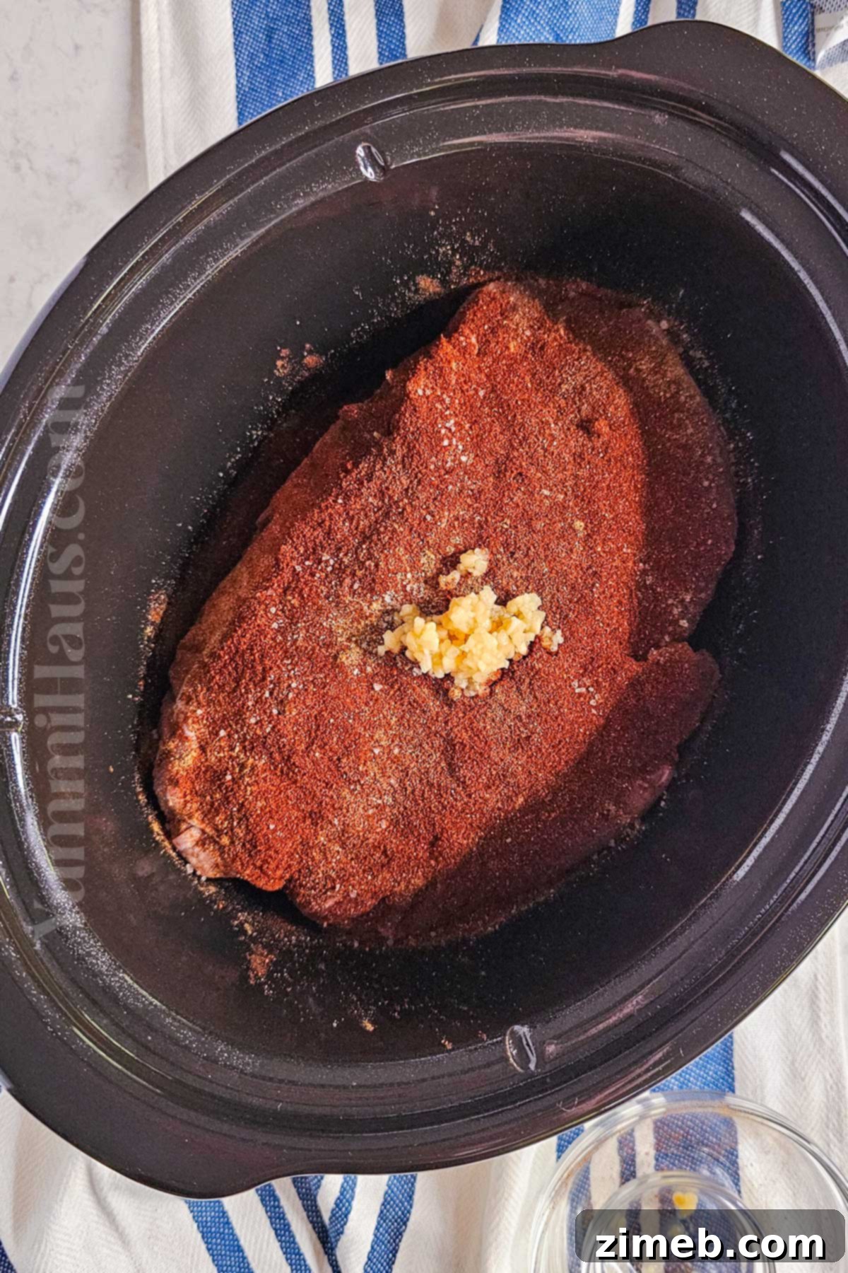 Melt-in-Your-Mouth Shredded Beef 5 Seasoning the chuck roast before slow cooking
