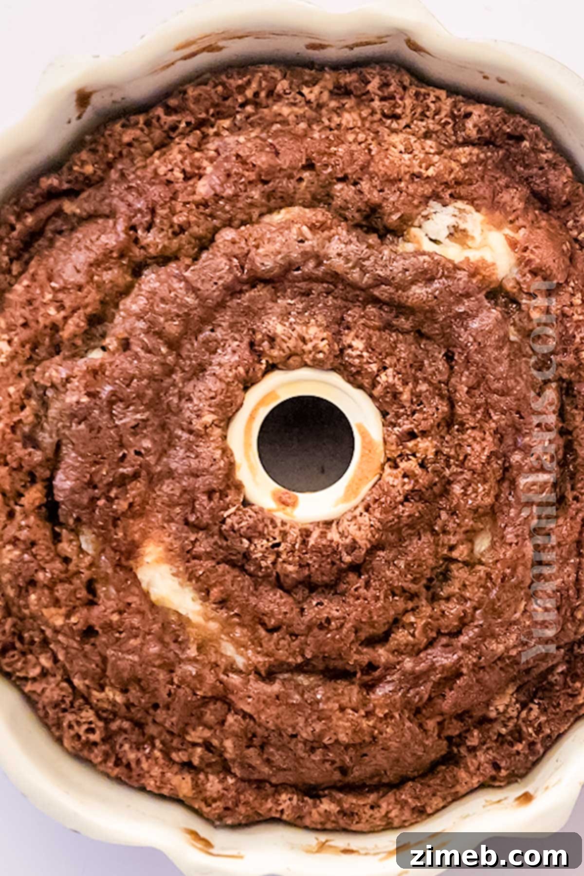 A baker preparing Carrot Bundt Cake, showing the layering process.