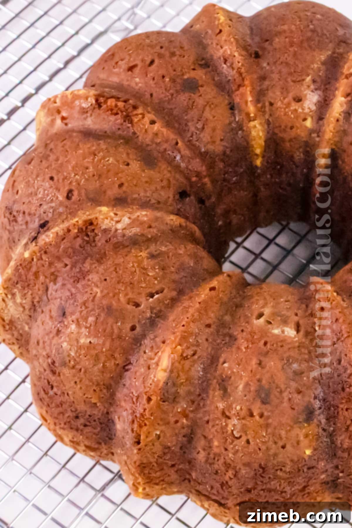 Rich Carrot Cake with Silken Cream Cheese Frosting 7 baked bundt cake cooling on a rack