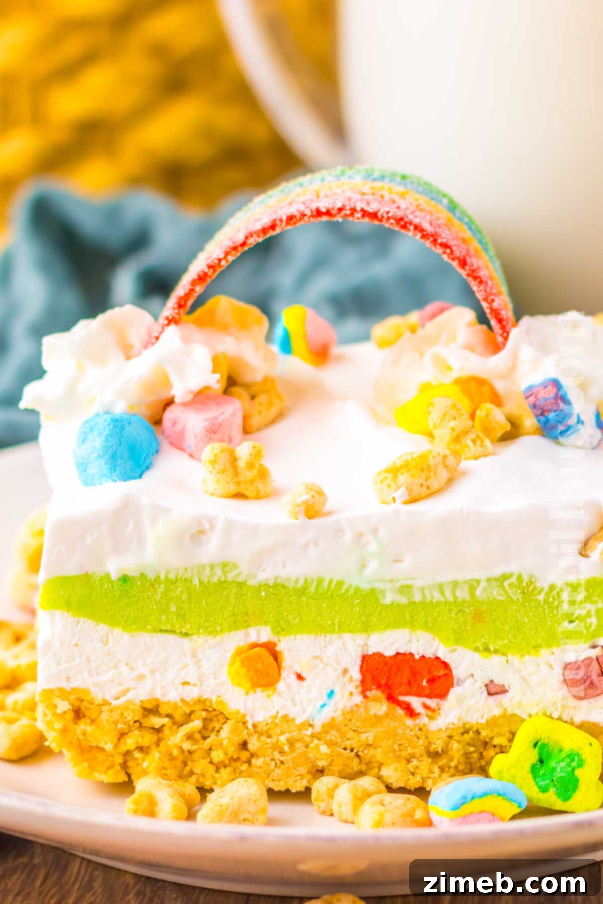 Rainbow Charm Elixir 2 Lucky Charms Lush recipe: A layered no-bake dessert with creamy pudding, whipped topping, and a crunchy cereal crust, perfect for St. Patrick's Day