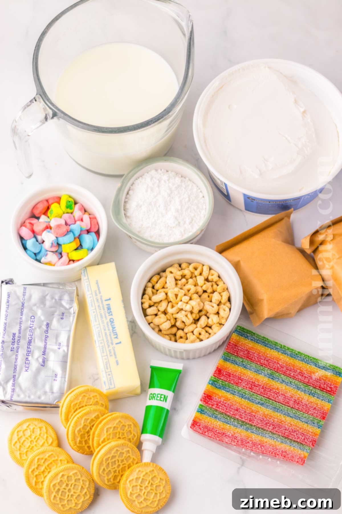 Rainbow Charm Elixir 4 All the ingredients laid out for making Lucky Charms Lush, including Oreos, cereal, cream cheese, and whipped topping