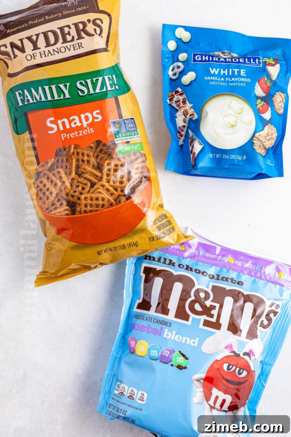 Blossom Pretzel Treats 4 Ingredients for Flower Pretzel Bites: pretzels, white chocolate melts, and M&Ms