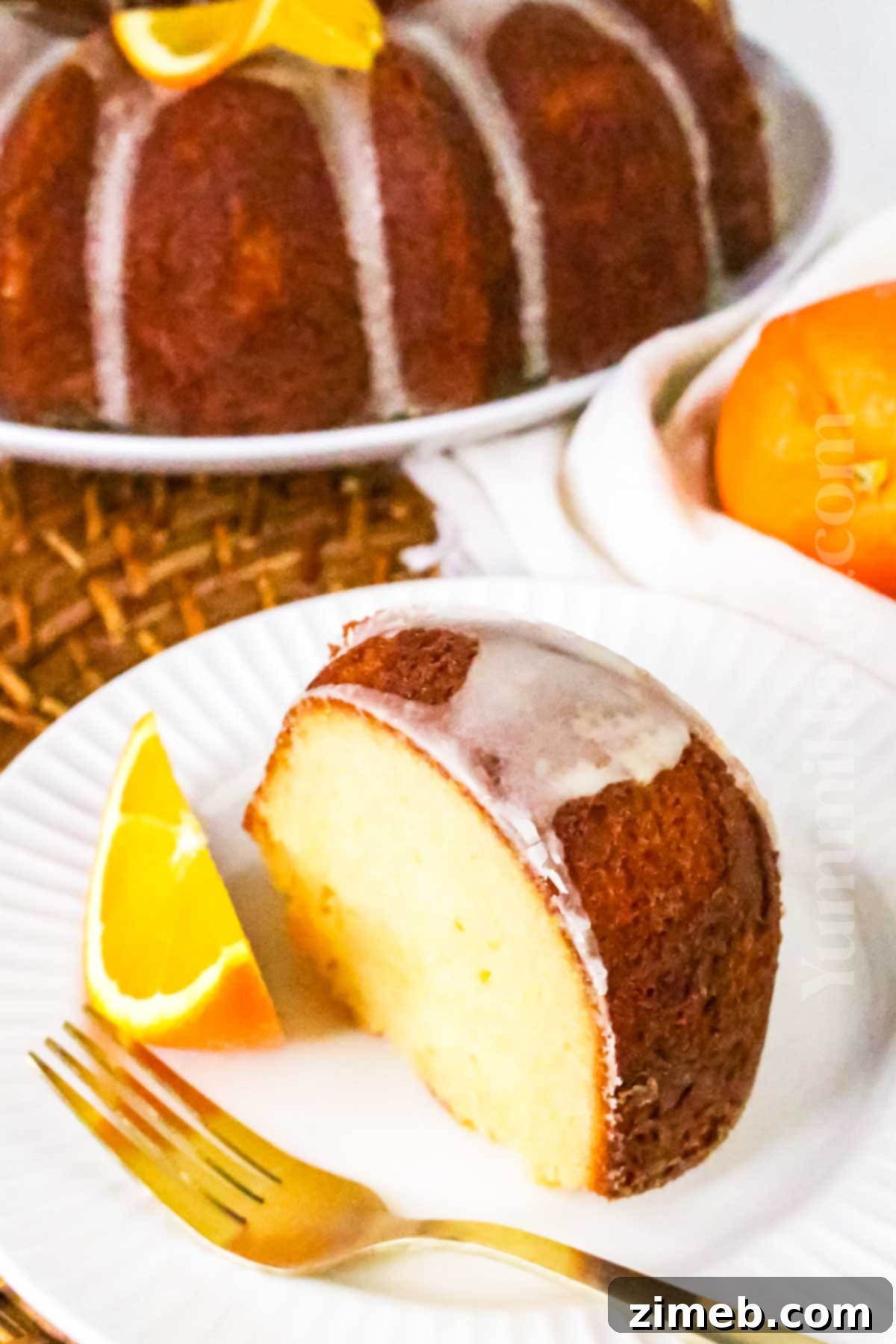 Zesty Orange Loaf 15 An Orange Pound Bundt Cake garnished with fresh oranges, ready to serve.