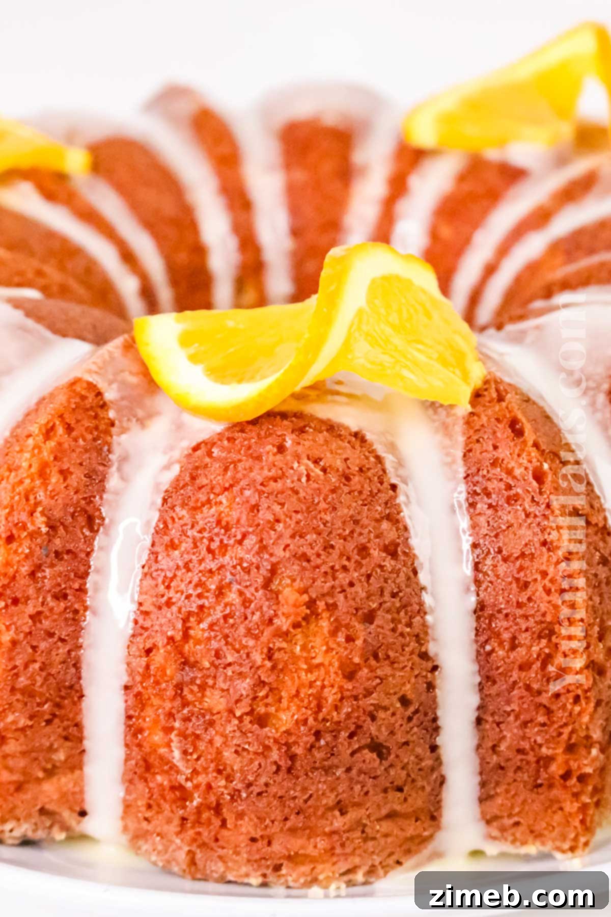 Zesty Orange Loaf 7 A slice of moist orange pound cake with glaze, ready to be enjoyed.
