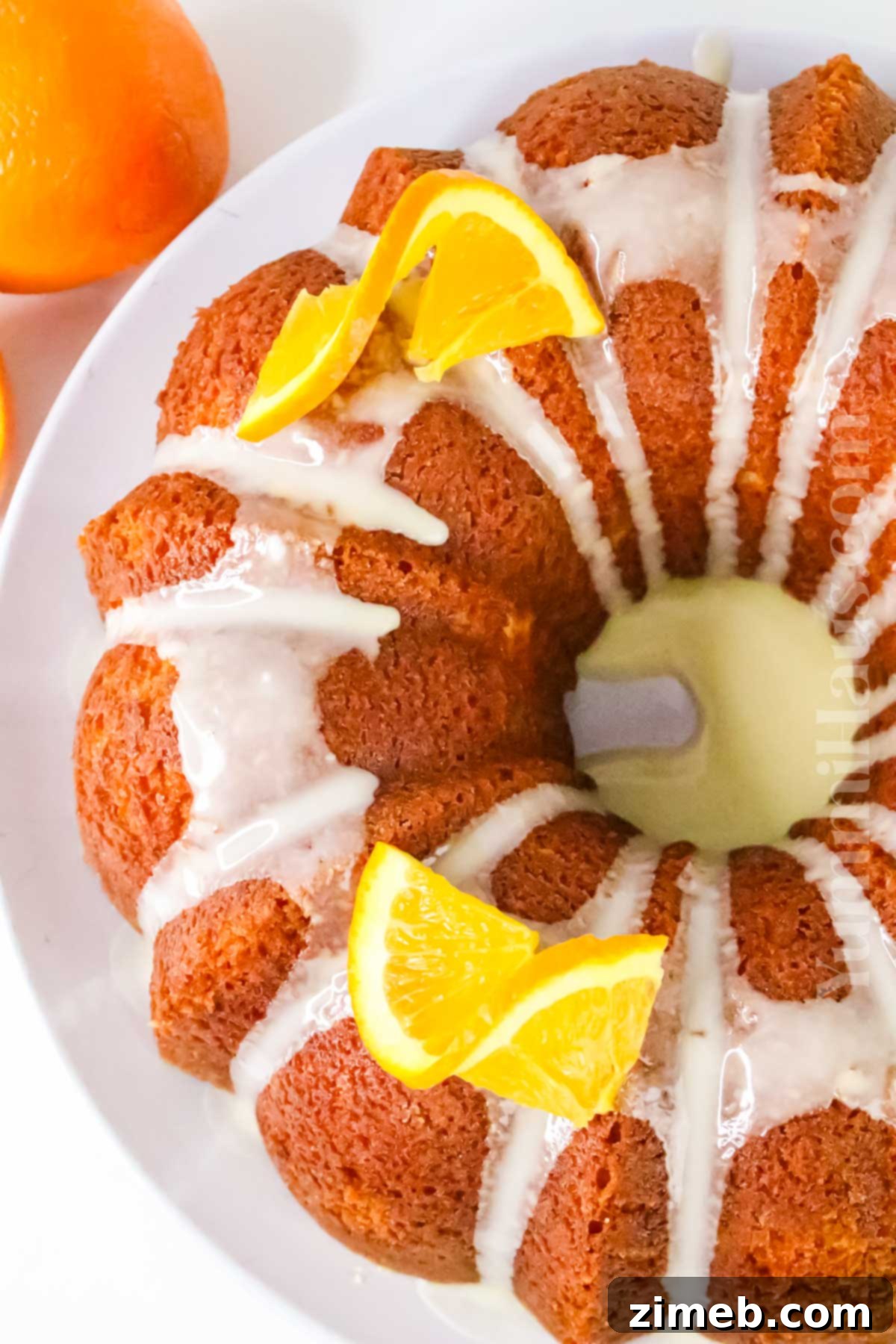 Zesty Orange Loaf 8 Glazed Orange Bundt Cake on a serving platter, beautifully decorated.